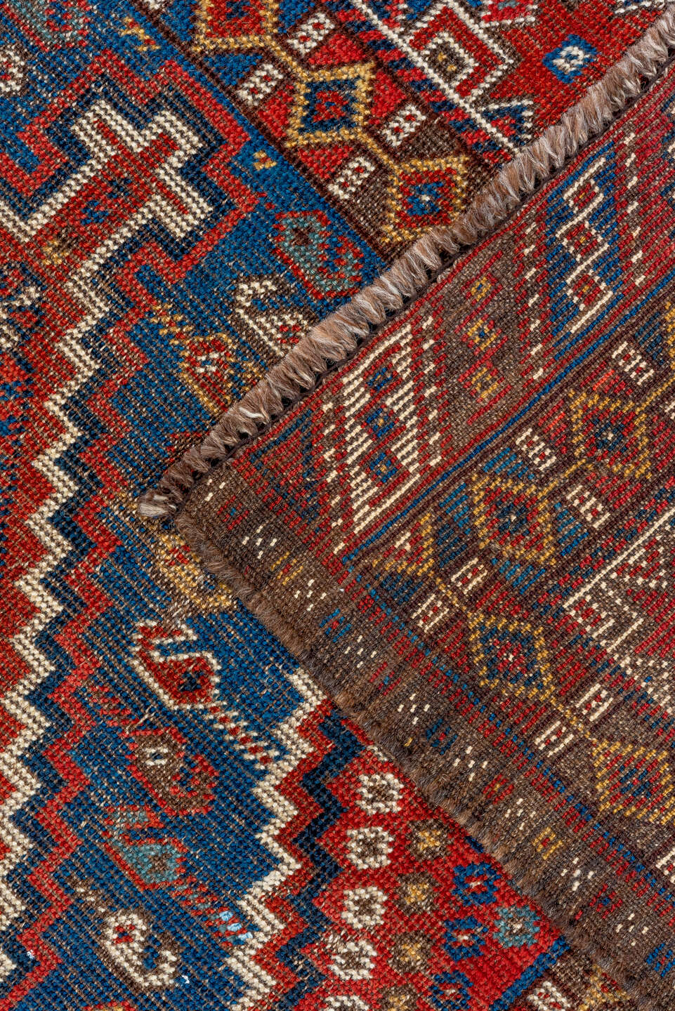 7' x 9' one-of-a-kind handmade vintage Shiraz rug. Color palette: rust, indigo, camel, ivory, crimson, navy, gold, brown