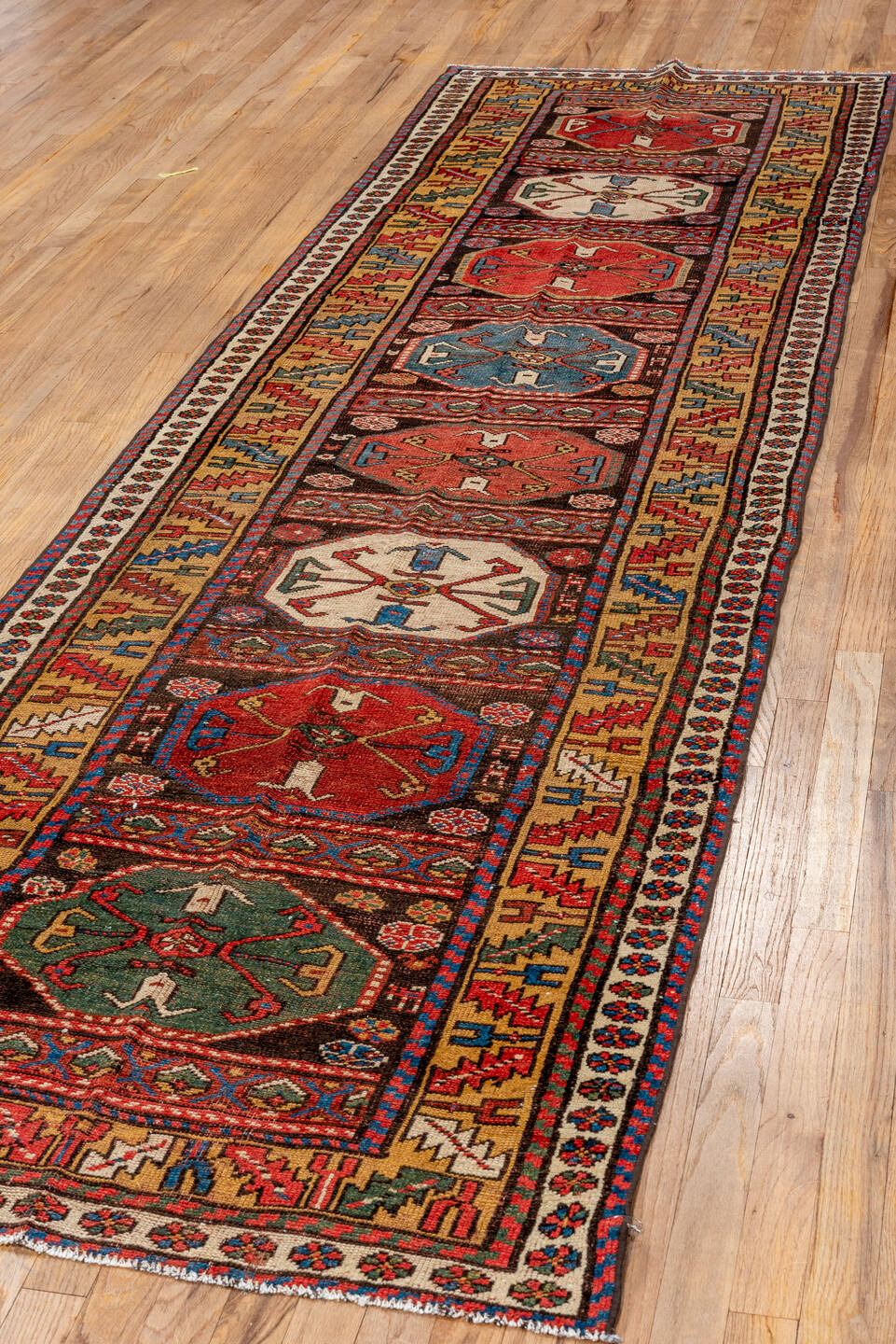 3' x 12' one-of-a-kind handmade vintage Kurd runner rug. Color palette: black, blue, brown, gray, off-white, orange, red