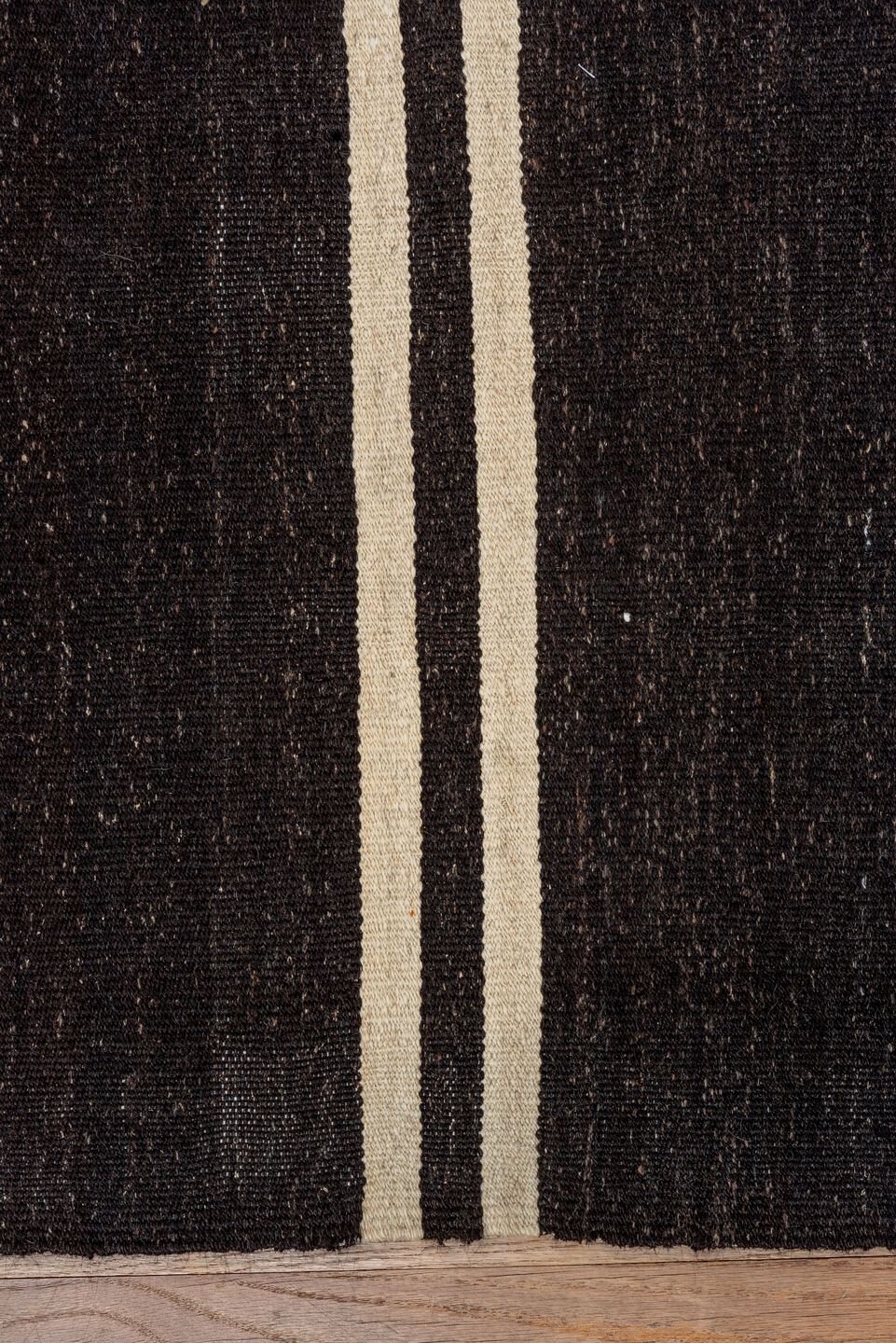 5' x 11' one-of-a-kind handmade vintage rug. Color palette: black, brown, gray, off-white, orange, red