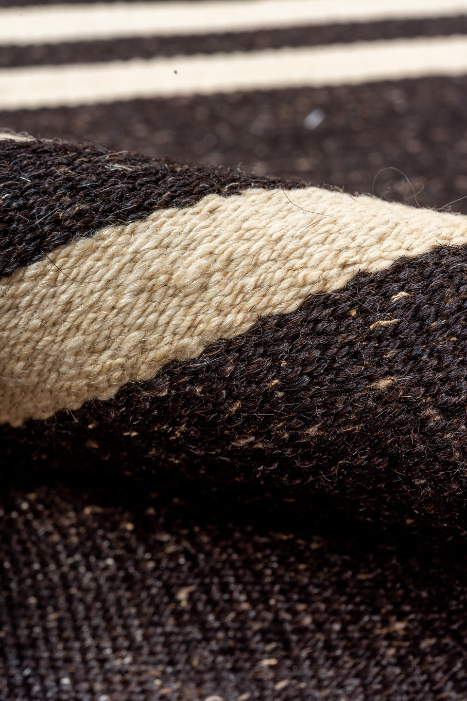 5' x 11' one-of-a-kind handmade vintage rug. Color palette: black, brown, gray, off-white, orange, red