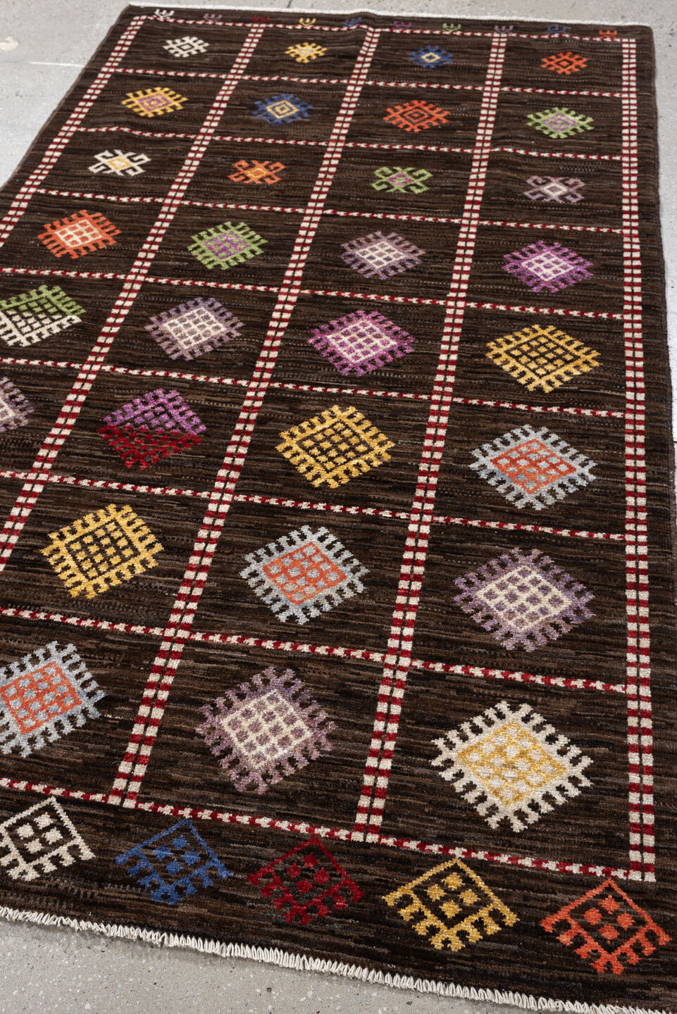 4' x 6' one-of-a-kind handmade vintage Jijim rug. Color palette: dark brown, ivory, coral, lavender, saffron, blue, sage