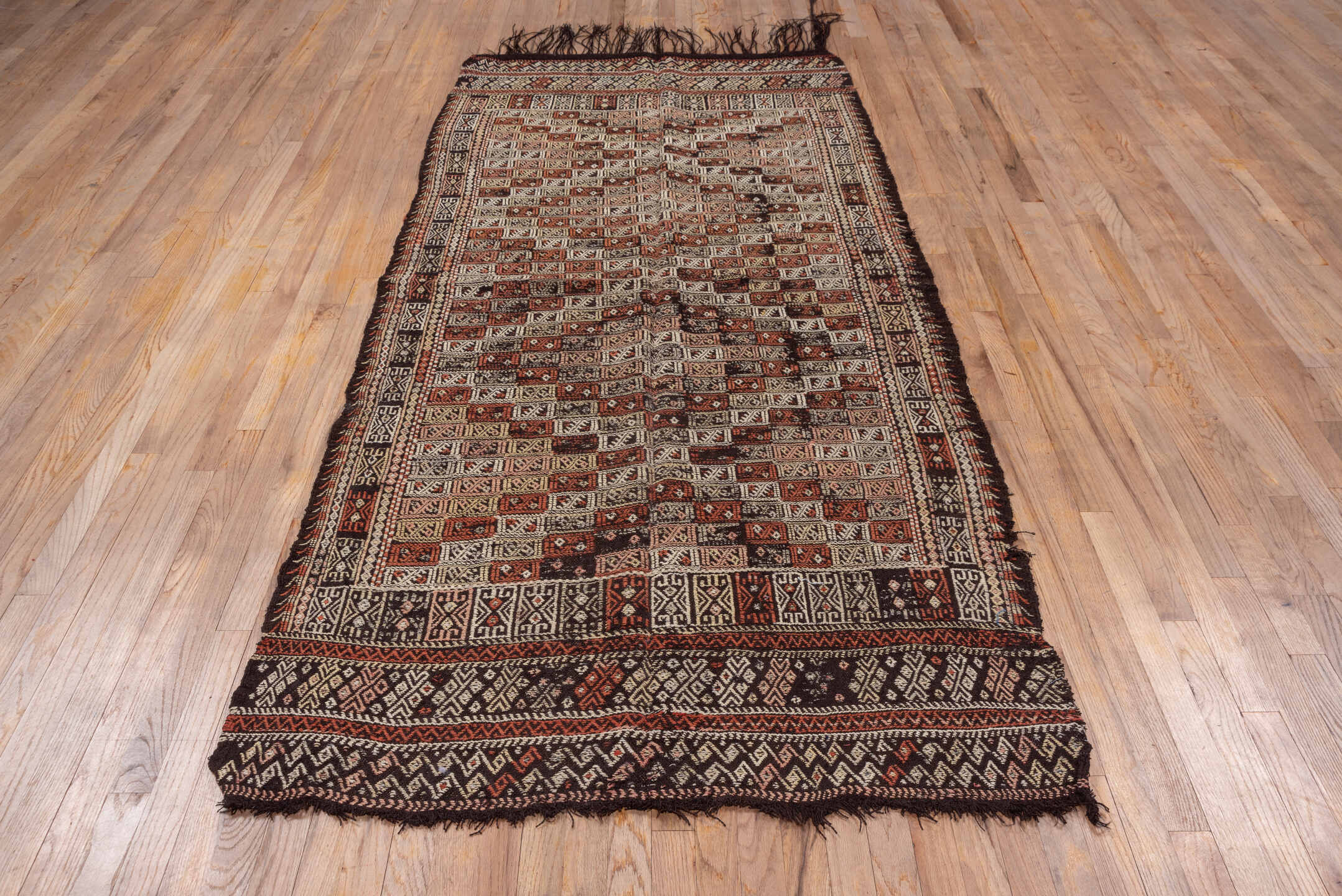 4' x 8' one-of-a-kind handmade vintage Jijim runner rug. Color palette: brown, gray, light gray, pink, redwood