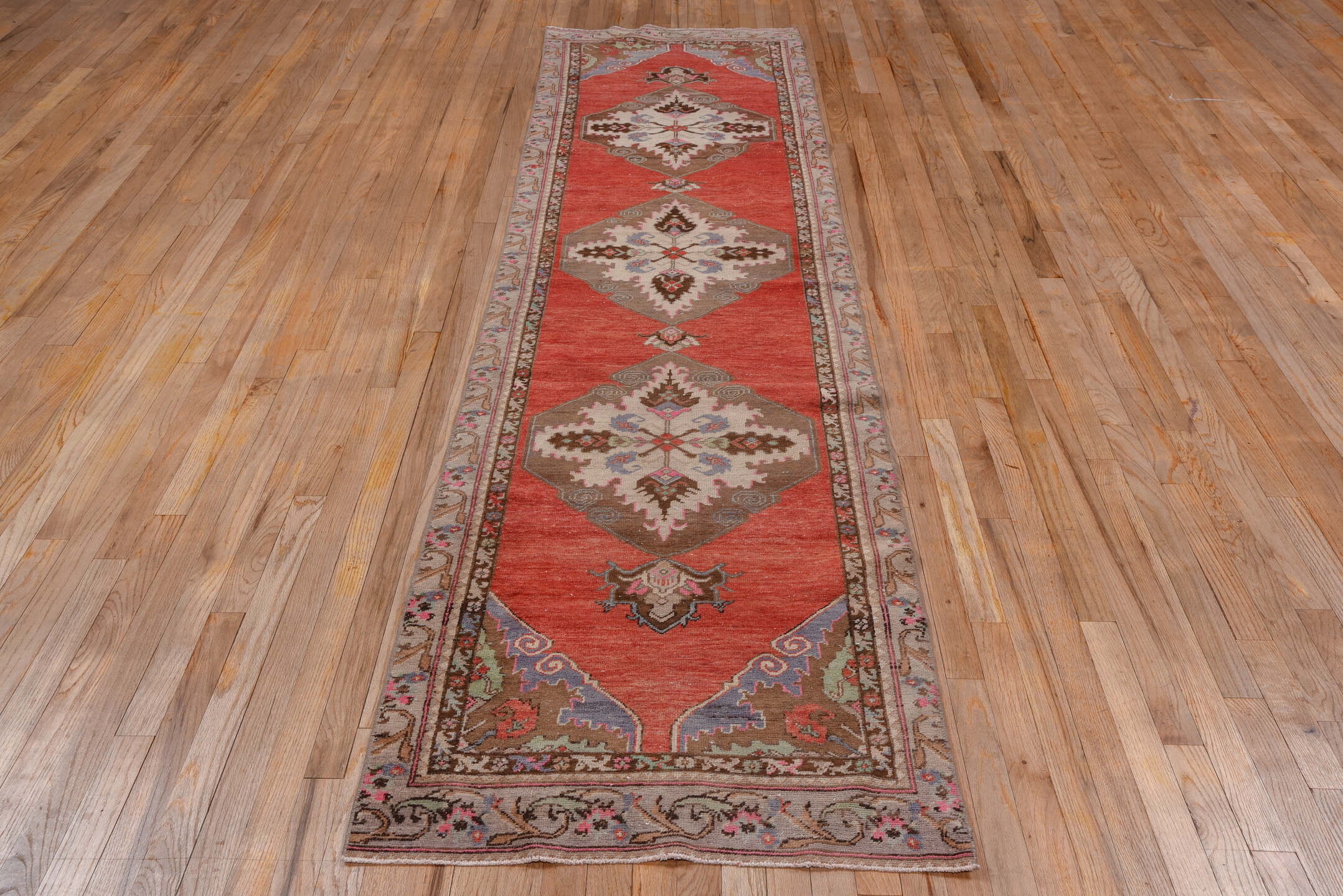 2' x 10' one-of-a-kind handmade vintage Oushak runner rug. Color palette: brown, gray, indian red, pink, red, redwood