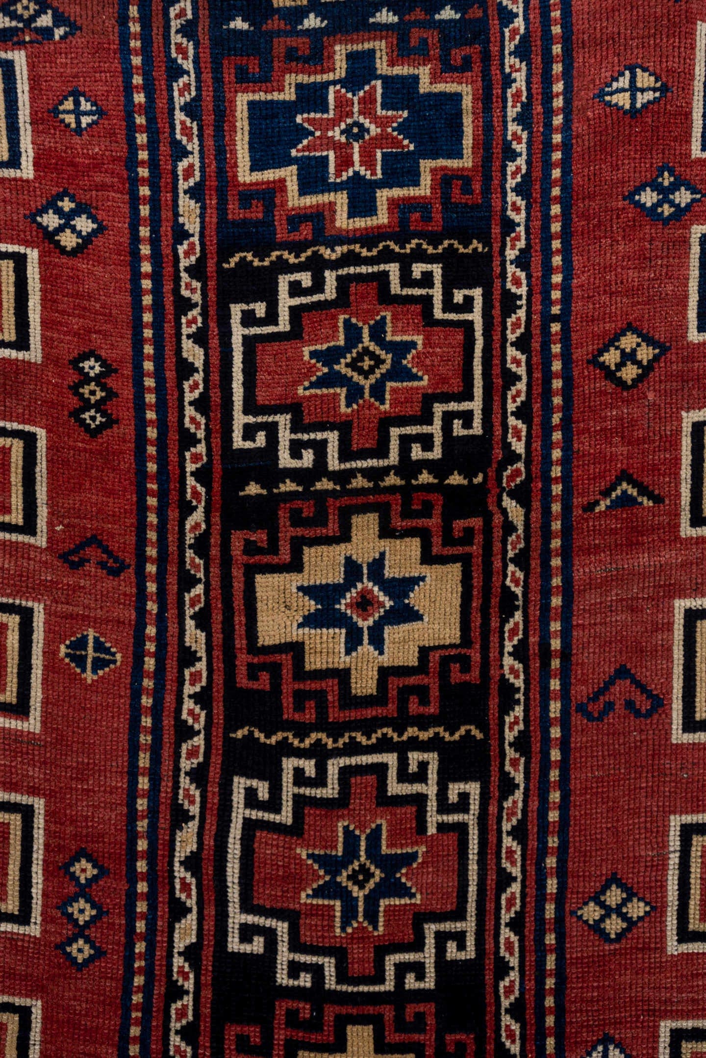 4' x 6' one-of-a-kind handmade antique Trans Caucasian small size rug. Color palette: rust, navy, ivory, crimson, indigo