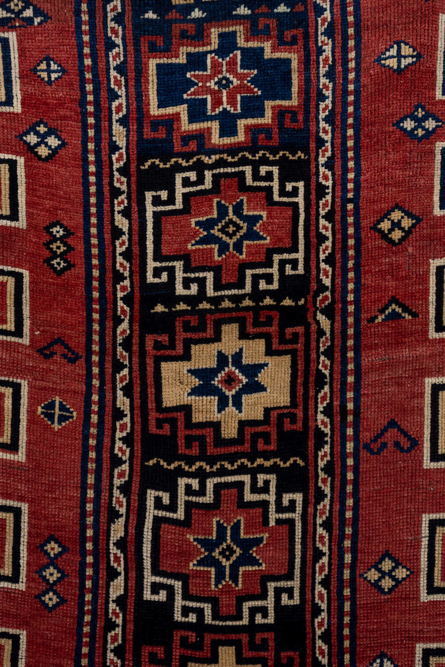 4' x 6' one-of-a-kind handmade antique Trans Caucasian small size rug. Color palette: rust, navy, ivory, crimson, indigo