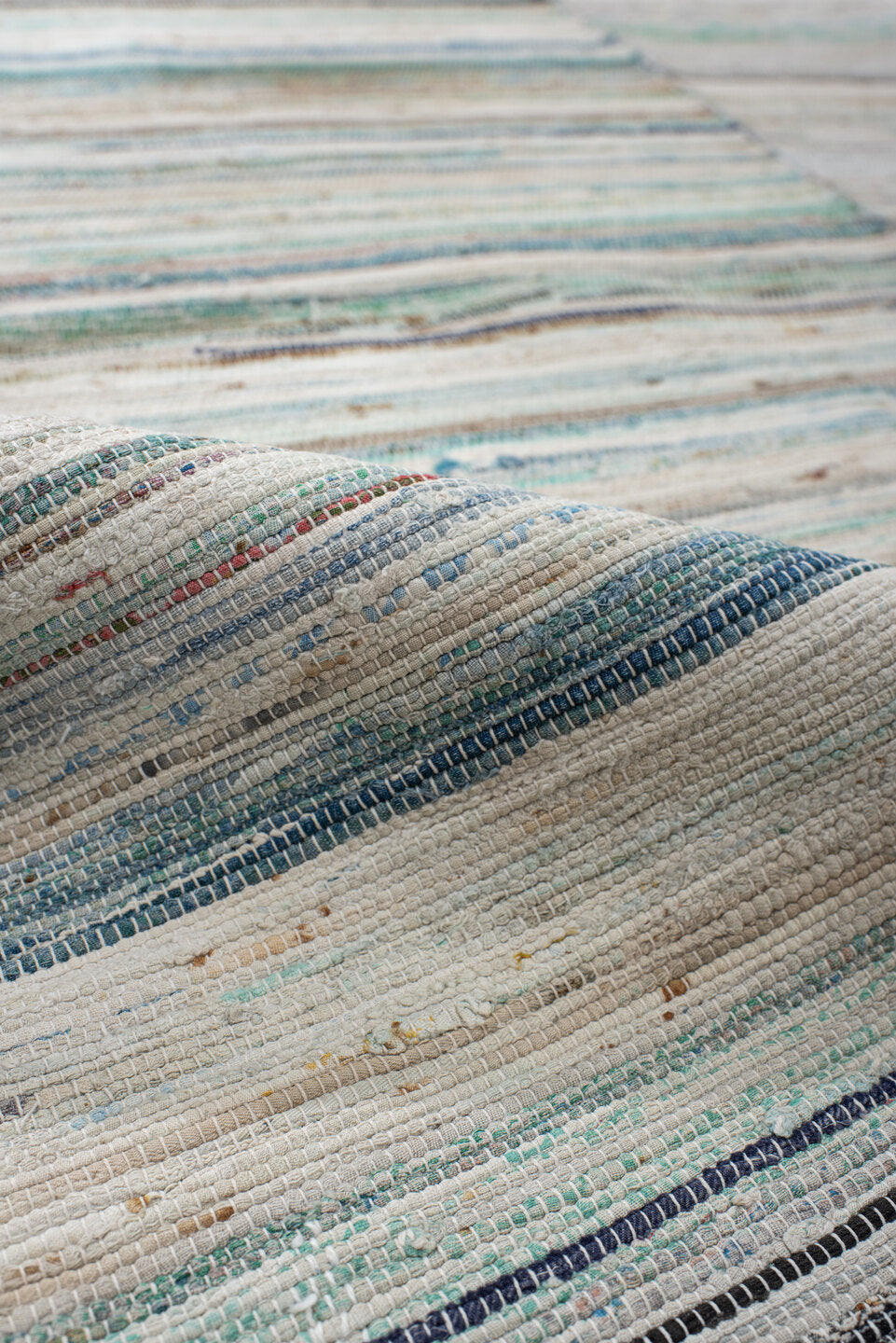 6' x 9' one-of-a-kind handmade antique Rag Rug medium size rug. Color palette: ivory, aqua, pale blue, charcoal, slate, rose