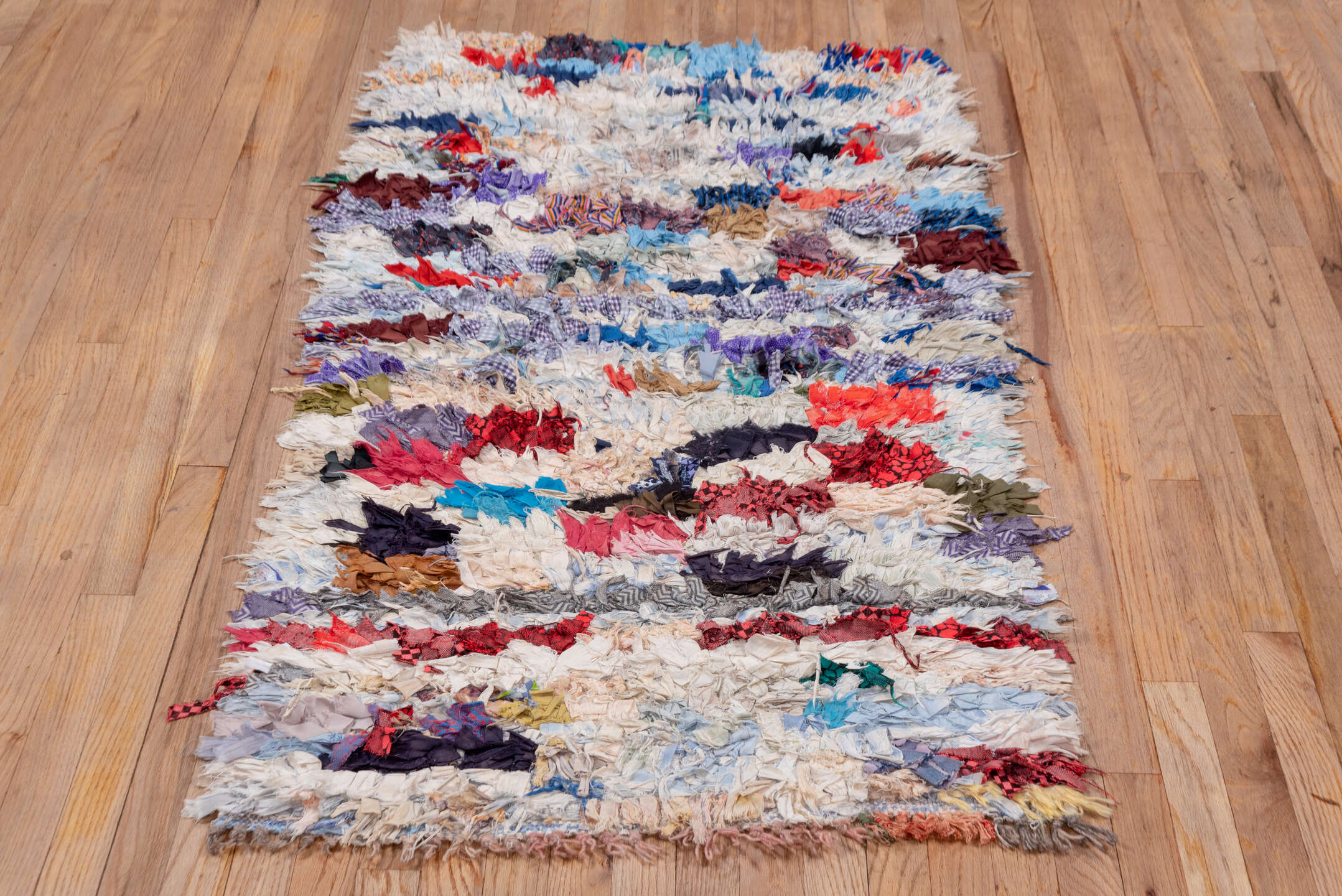 2' x 5' one-of-a-kind handmade vintage Rag Rug small size rug. Color palette: ivory, pale blue, navy, crimson, brown, violet