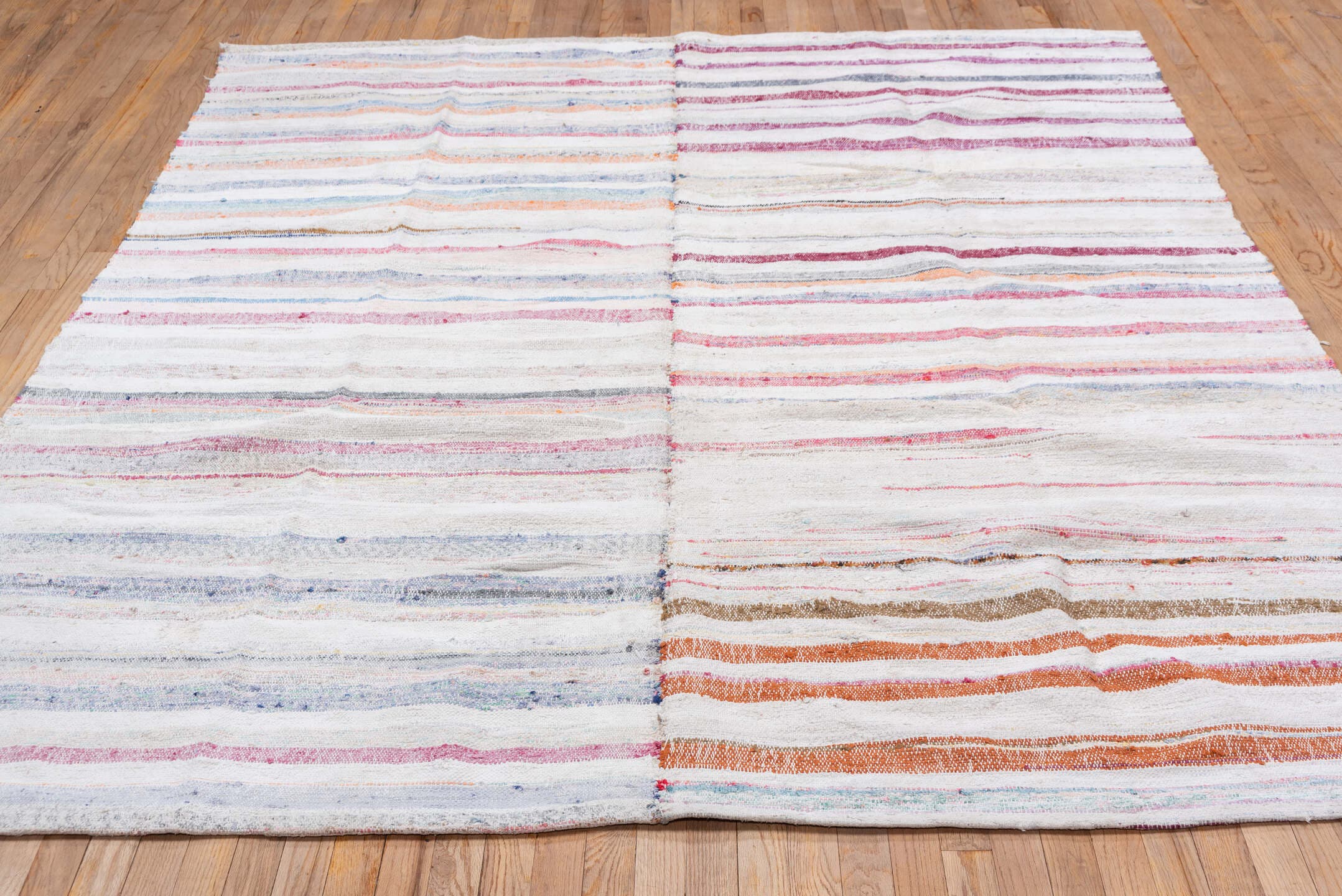 7' x 8' one-of-a-kind handmade antique Rag Rug rug. Color palette: ivory, rose, pale blue, peach, gray, tan, pink, red