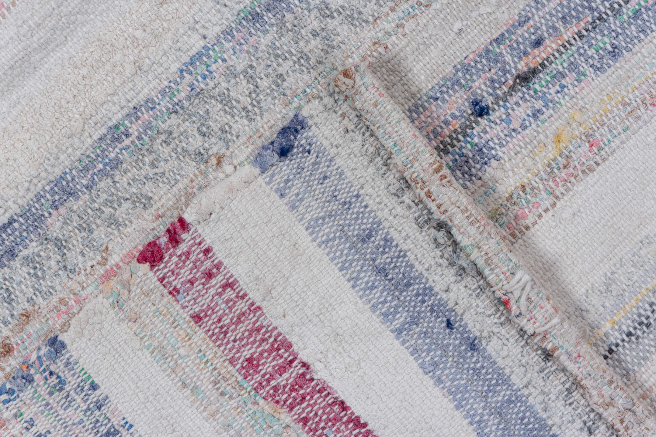 7' x 8' one-of-a-kind handmade vintage Rag Rug rug. Color palette: blue, gray, light blue, light gray, off-white, pink