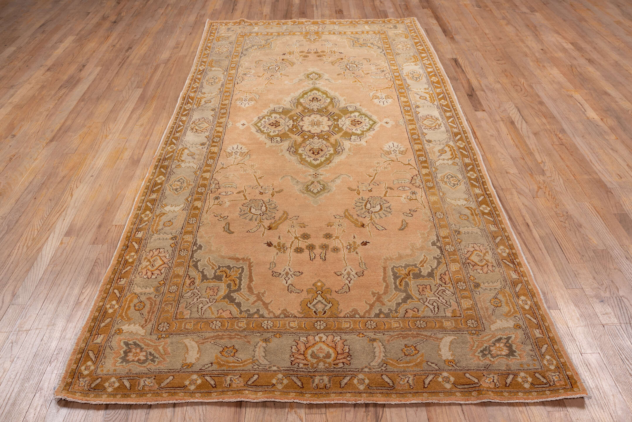 5' x 10' one-of-a-kind handmade antique Agra medium size rug. Color palette: peach, camel, ivory, taupe, gold, olive, brown