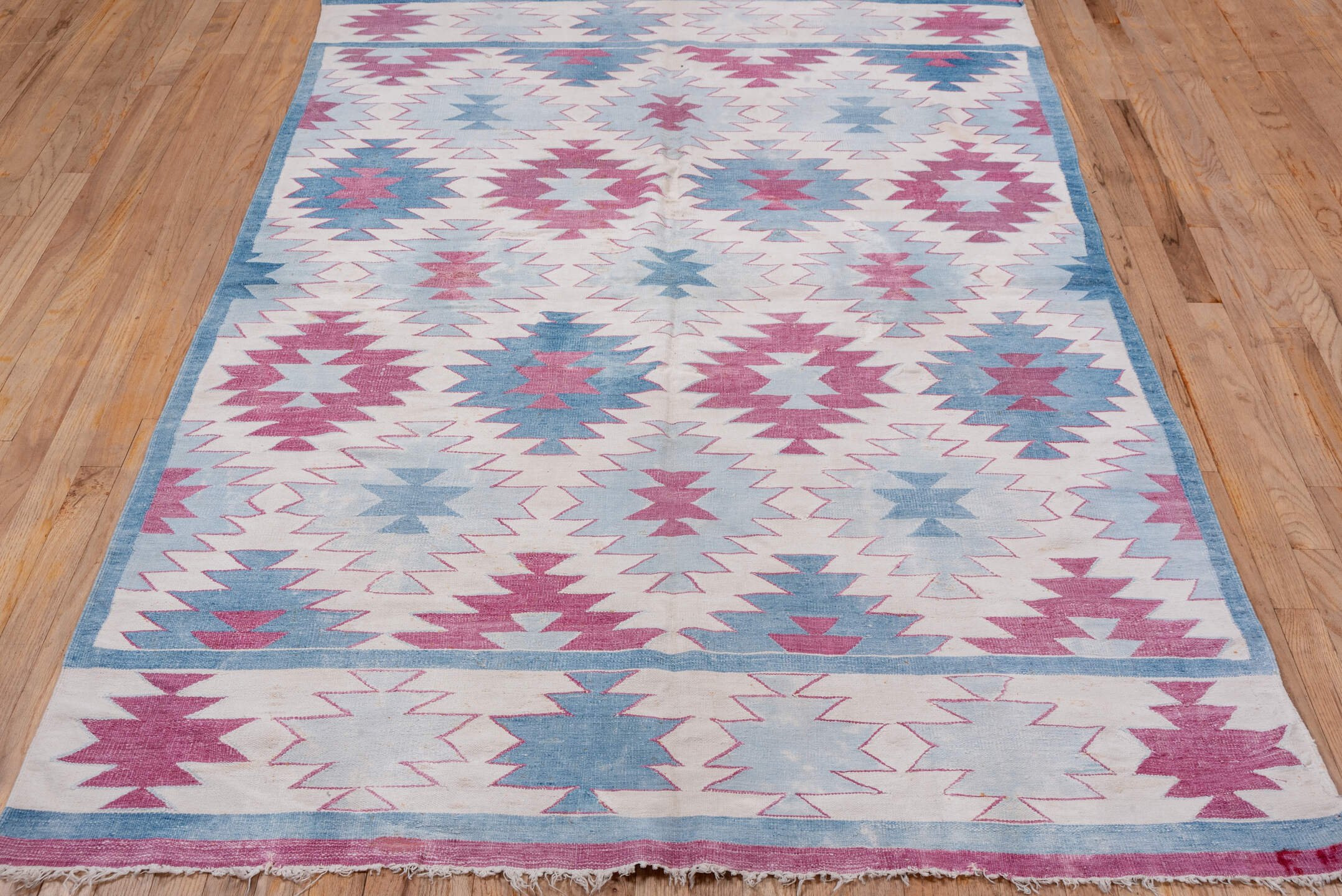 5' x 7' one-of-a-kind handmade antique Dhurrie rug. Color palette: ivory, sky blue, rose, dusty pink, light blue, pink, red