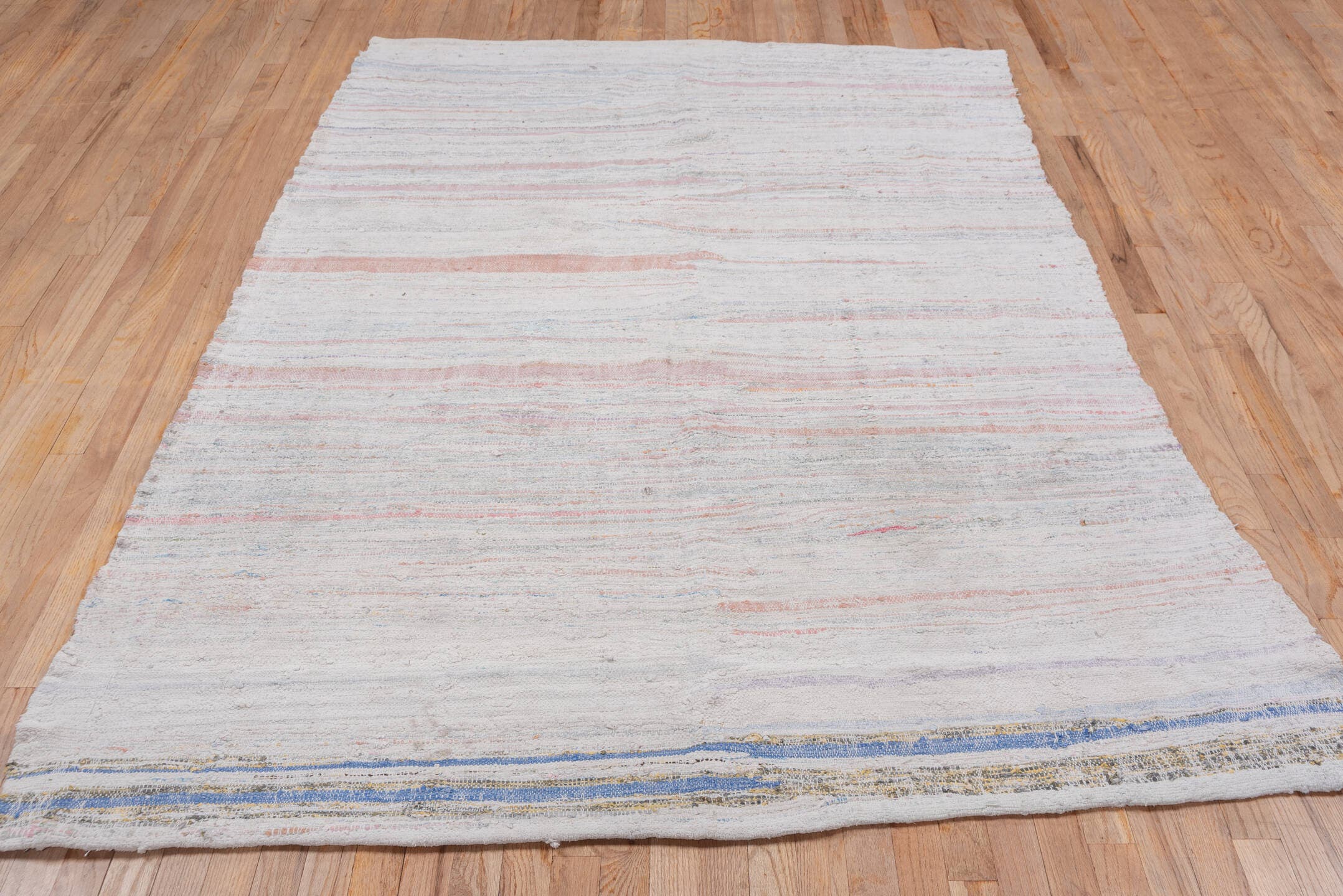 5' x 7' one-of-a-kind handmade antique Rag Rug rug. Color palette: ivory, blush, pale blue, peach, taupe, pink, light blue