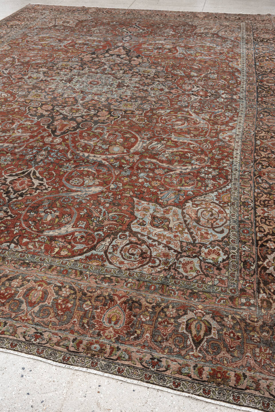 10' x 15' one-of-a-kind handmade antique Baktiary oversize rug. Color palette: terracotta, ivory, charcoal, sky blue, taupe