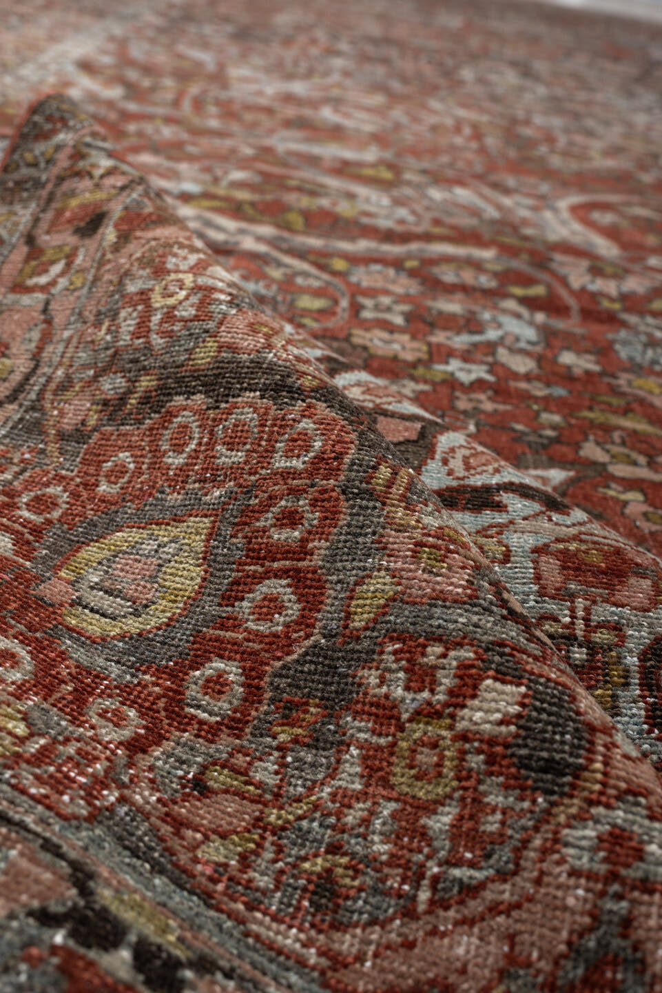10' x 15' one-of-a-kind handmade antique Baktiary oversize rug. Color palette: terracotta, ivory, charcoal, sky blue, taupe