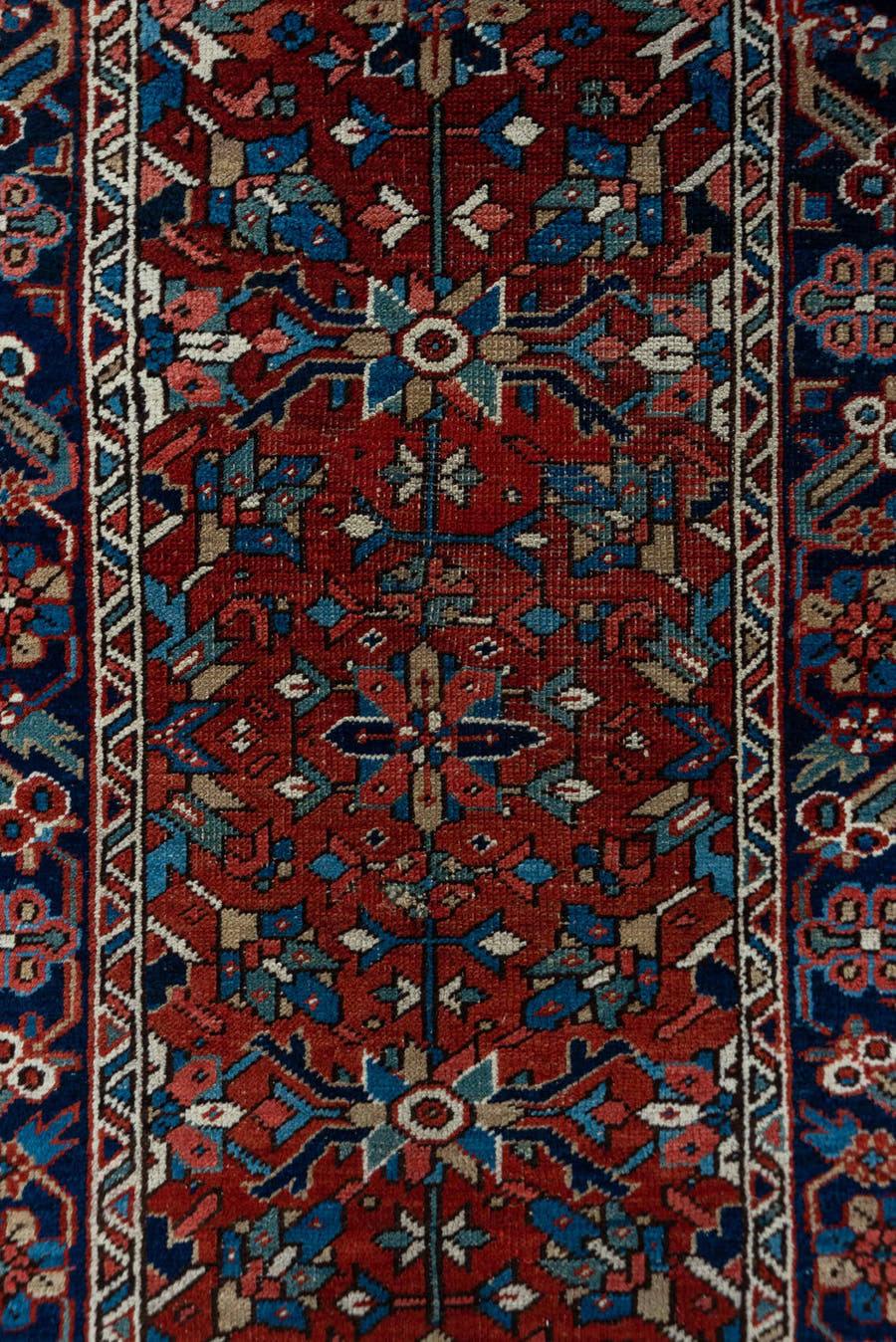 3' x 12' one-of-a-kind handmade vintage Heriz runner rug. Color palette: rust, navy, ivory, sky blue, rose, camel