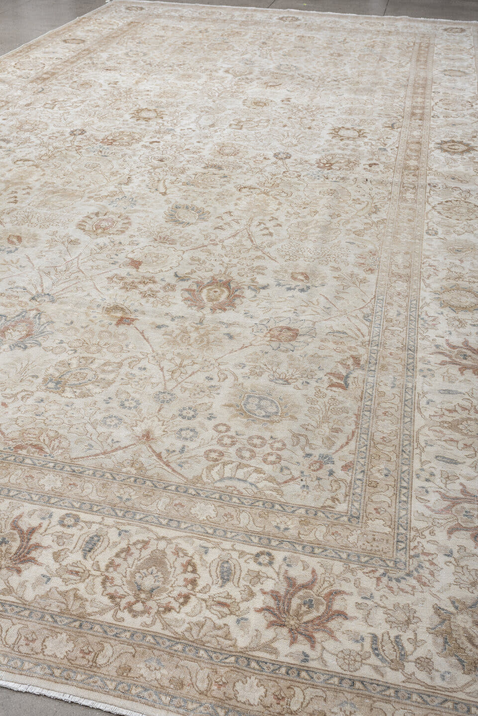 9' x 18' one-of-a-kind handmade antique Tabriz rug. Color palette: ivory, taupe, beige, camel, pale blue, sage, soft gold