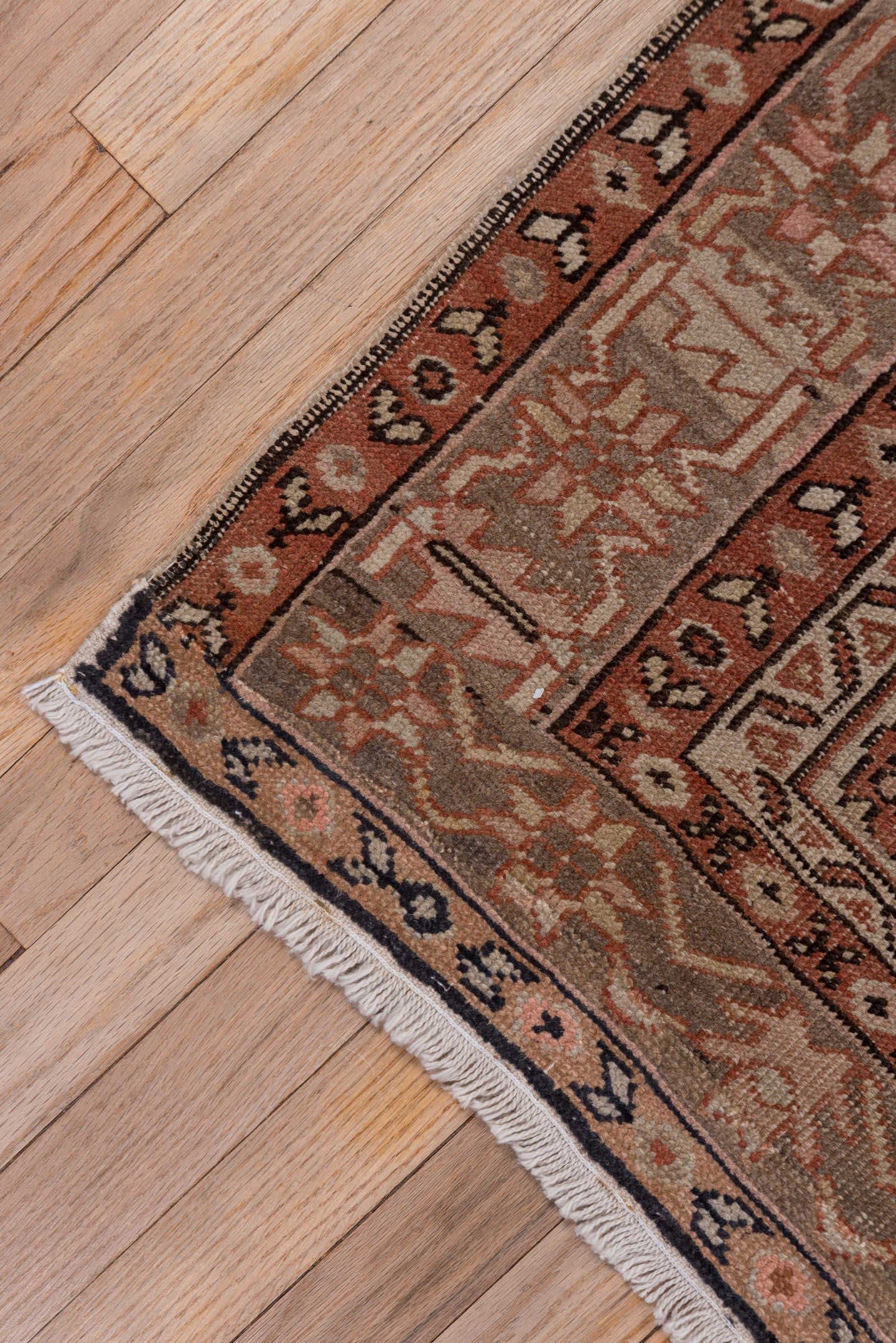 4' x 5' one-of-a-kind handmade antique Serapi small size rug. Color palette: terra cotta, taupe, brown, ivory, camel, slate