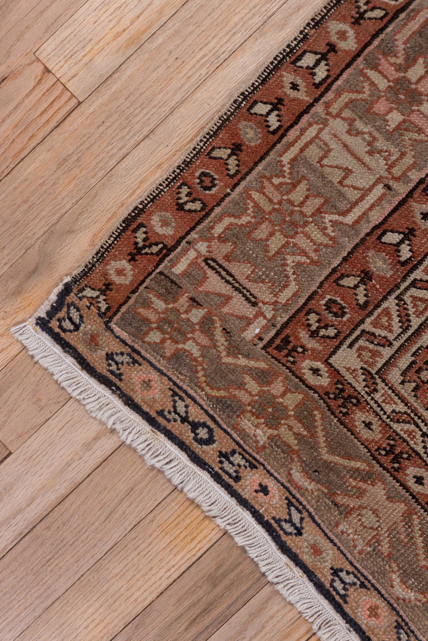 4' x 5' one-of-a-kind handmade antique Serapi small size rug. Color palette: terra cotta, taupe, brown, ivory, camel, slate