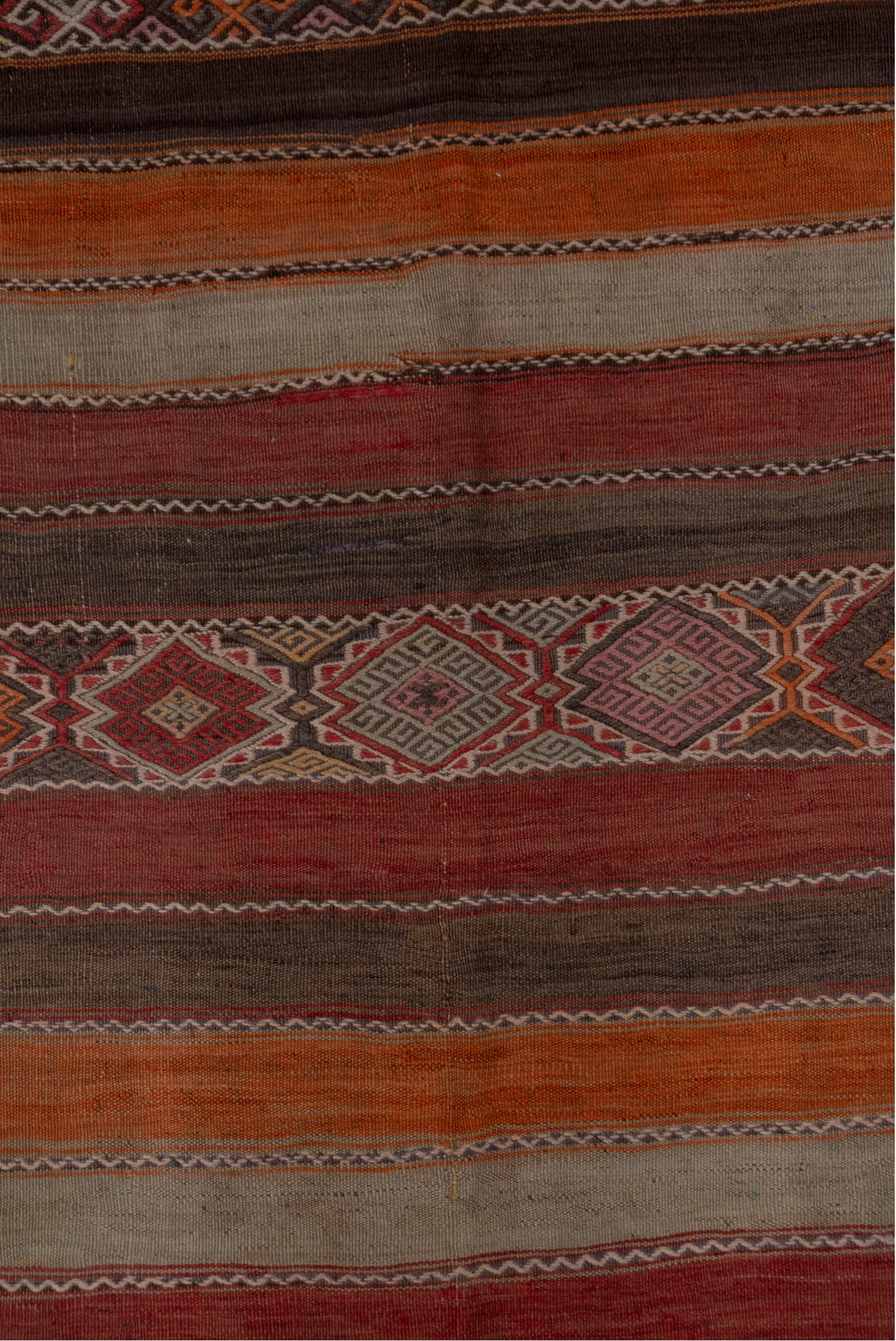 4' x 10' one-of-a-kind handmade vintage Jijim runner rug. Color palette: brown, gray, pink, red, redwood