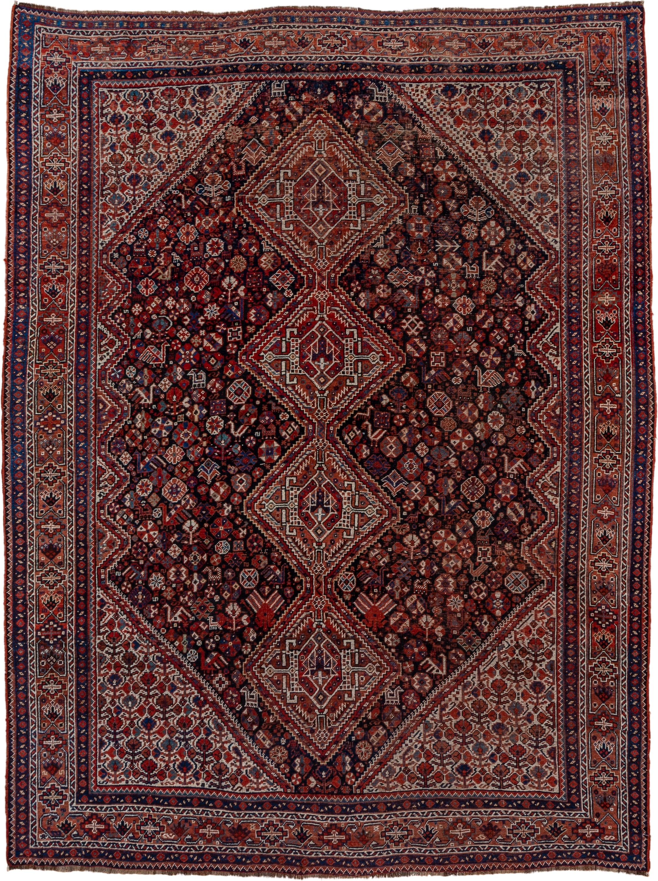 7' x 9' one-of-a-kind handmade antique Shiraz rug. Color palette: rust, navy, ivory, burgundy, terracotta, indigo, camel