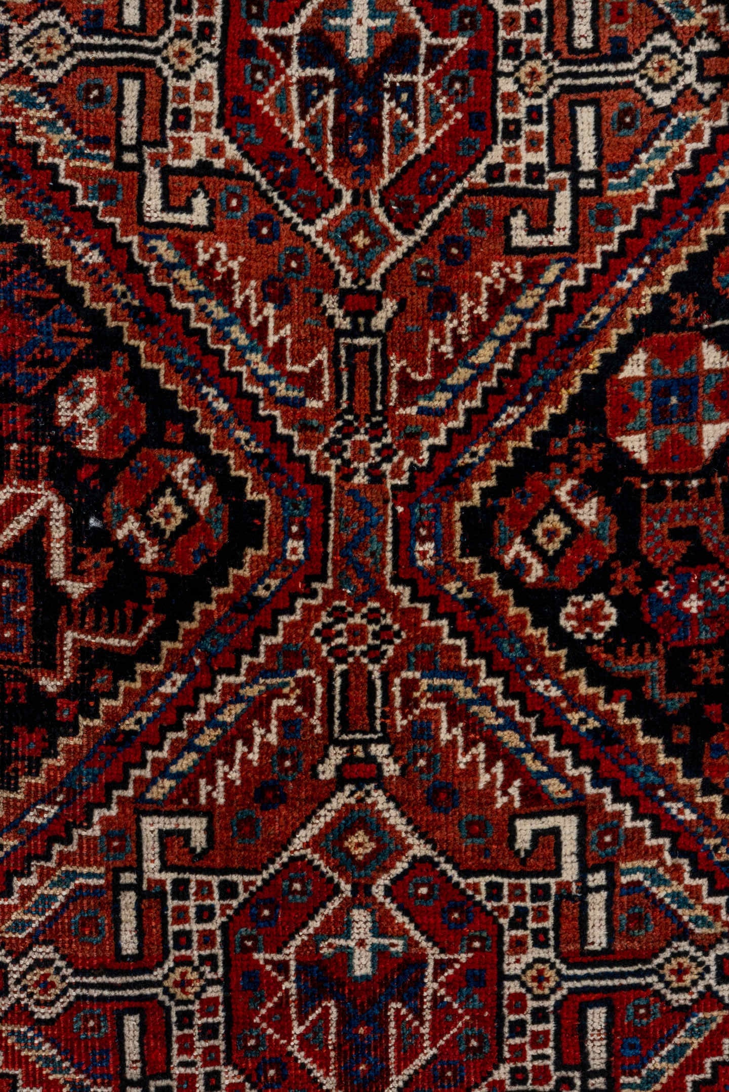 7' x 9' one-of-a-kind handmade antique Shiraz rug. Color palette: rust, navy, ivory, burgundy, terracotta, indigo, camel