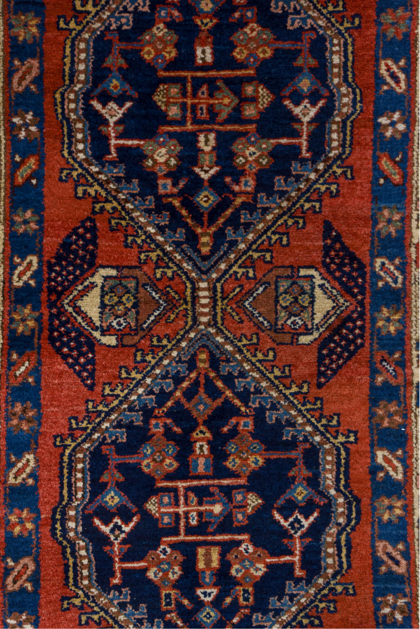 3' x 9' one-of-a-kind handmade vintage Heriz runner rug. Color palette: blue, brown, gray, maroon, pink, red, redwood