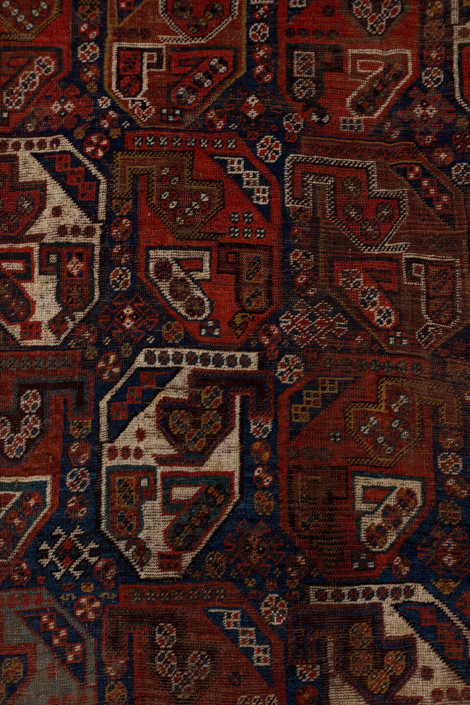 7' x 9' one-of-a-kind handmade antique Shiraz rug. Color palette: rust, indigo, ivory, brick, camel, navy, brown, terracotta