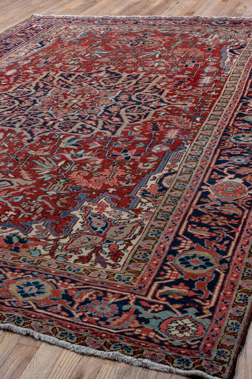 7' x 10' one-of-a-kind handmade antique Heriz large size rug. Color palette: red, navy, ivory, sky blue, rose, burgundy