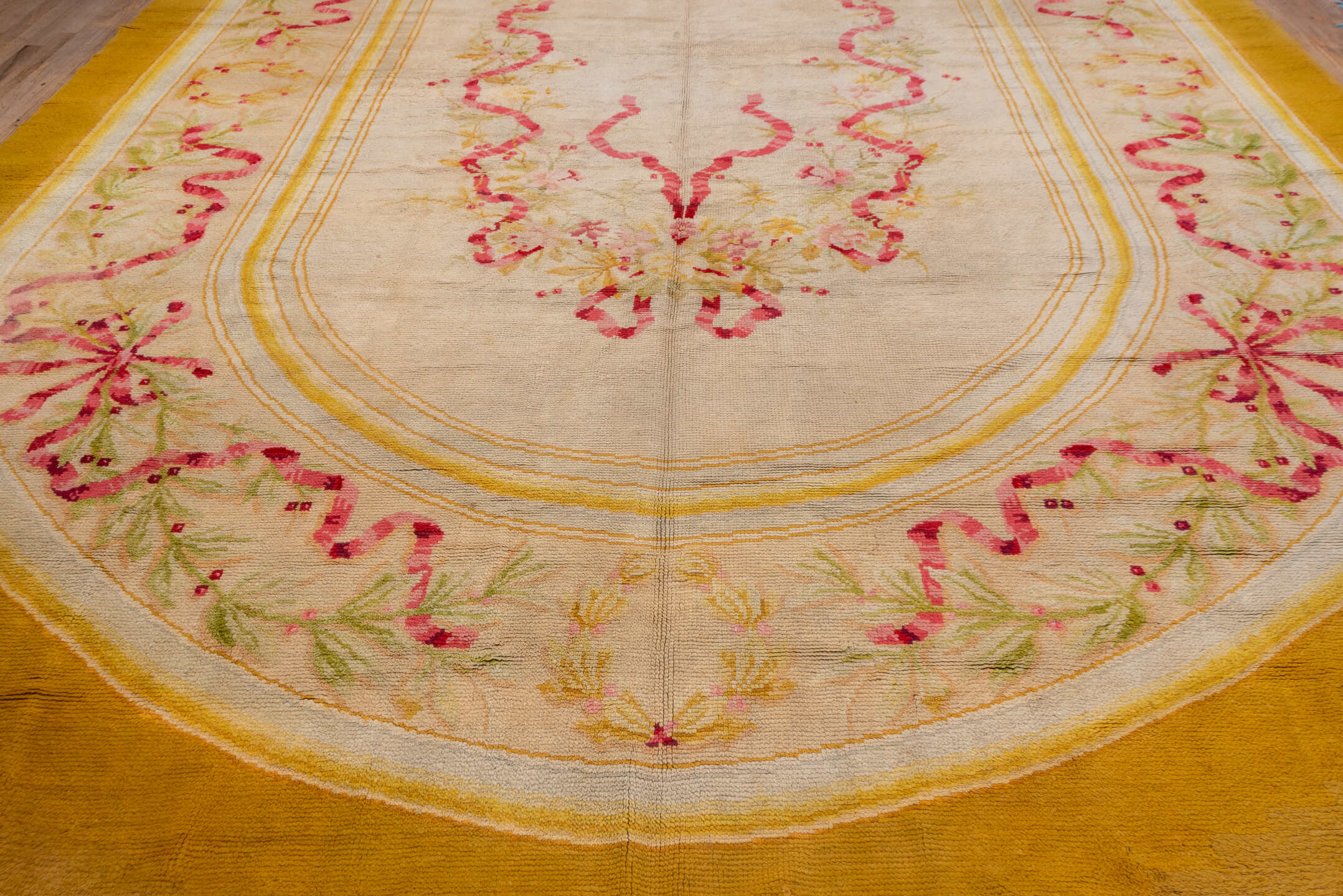 12' x 28' one-of-a-kind handmade antique Savonnerie oversize rug. Color palette: gold, ivory, rose, sage, cream, soft_green