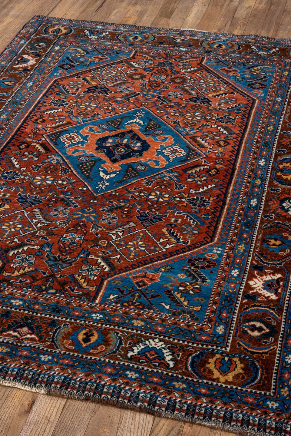 3' x 5' one-of-a-kind handmade vintage Shiraz small size rug. Color palette: rust, turquoise, navy, ivory, camel, brown