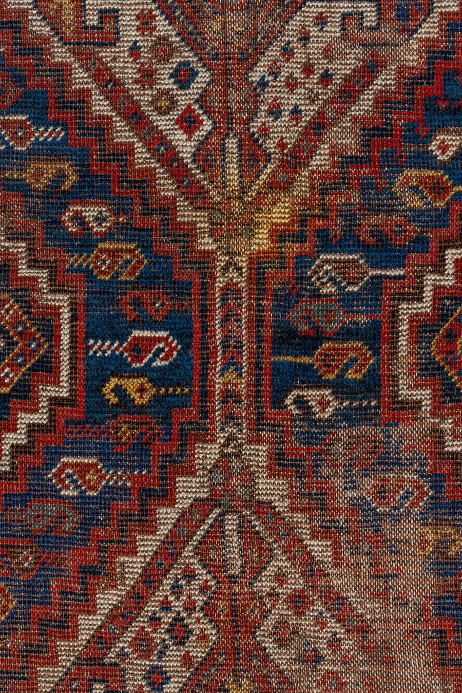 7' x 9' one-of-a-kind handmade vintage Shiraz rug. Color palette: rust, indigo, camel, ivory, crimson, navy, gold, brown