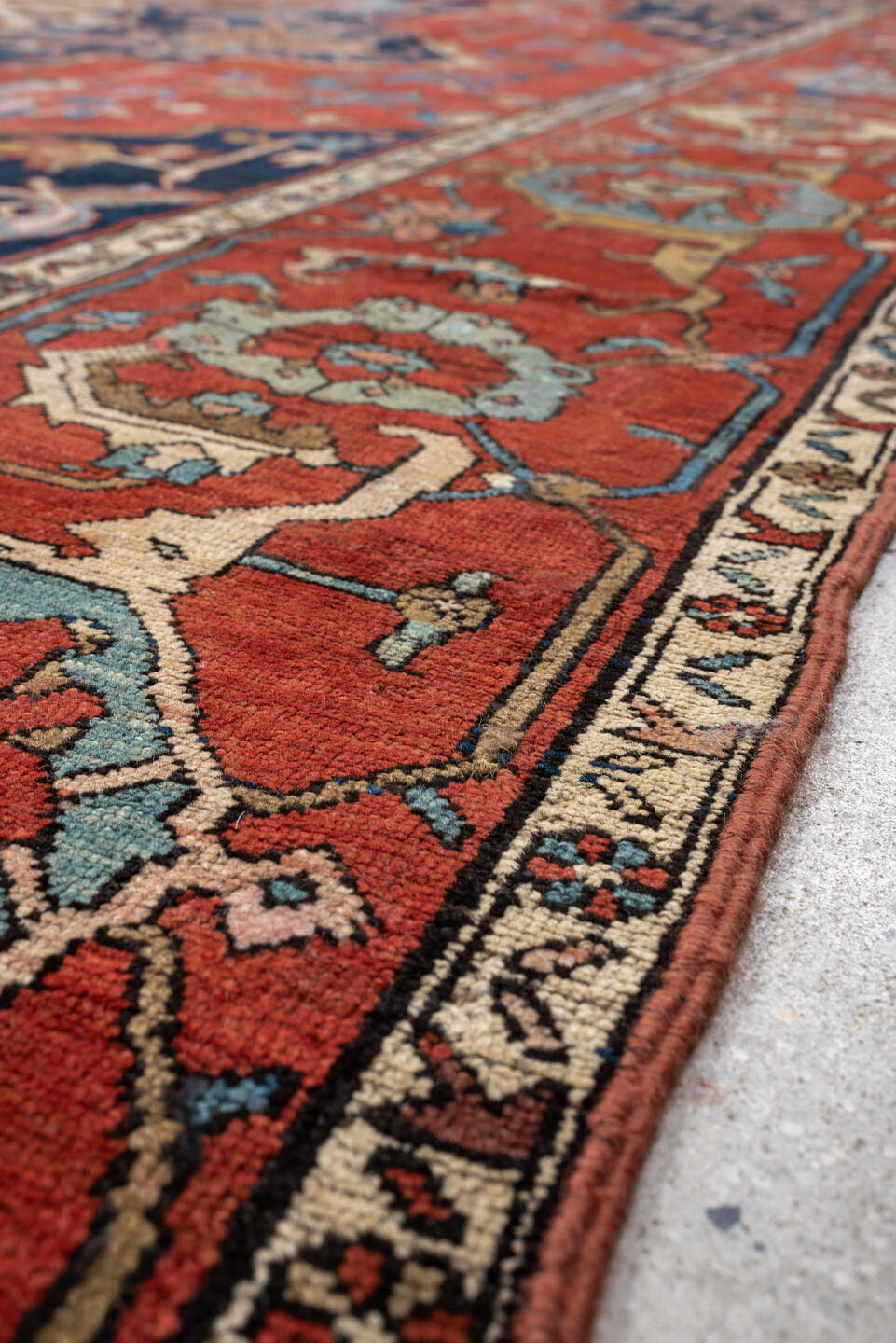 11' x 16' one-of-a-kind handmade antique Serapi oversize rug. Color palette: terracotta, navy, ivory, sky blue, camel, rose
