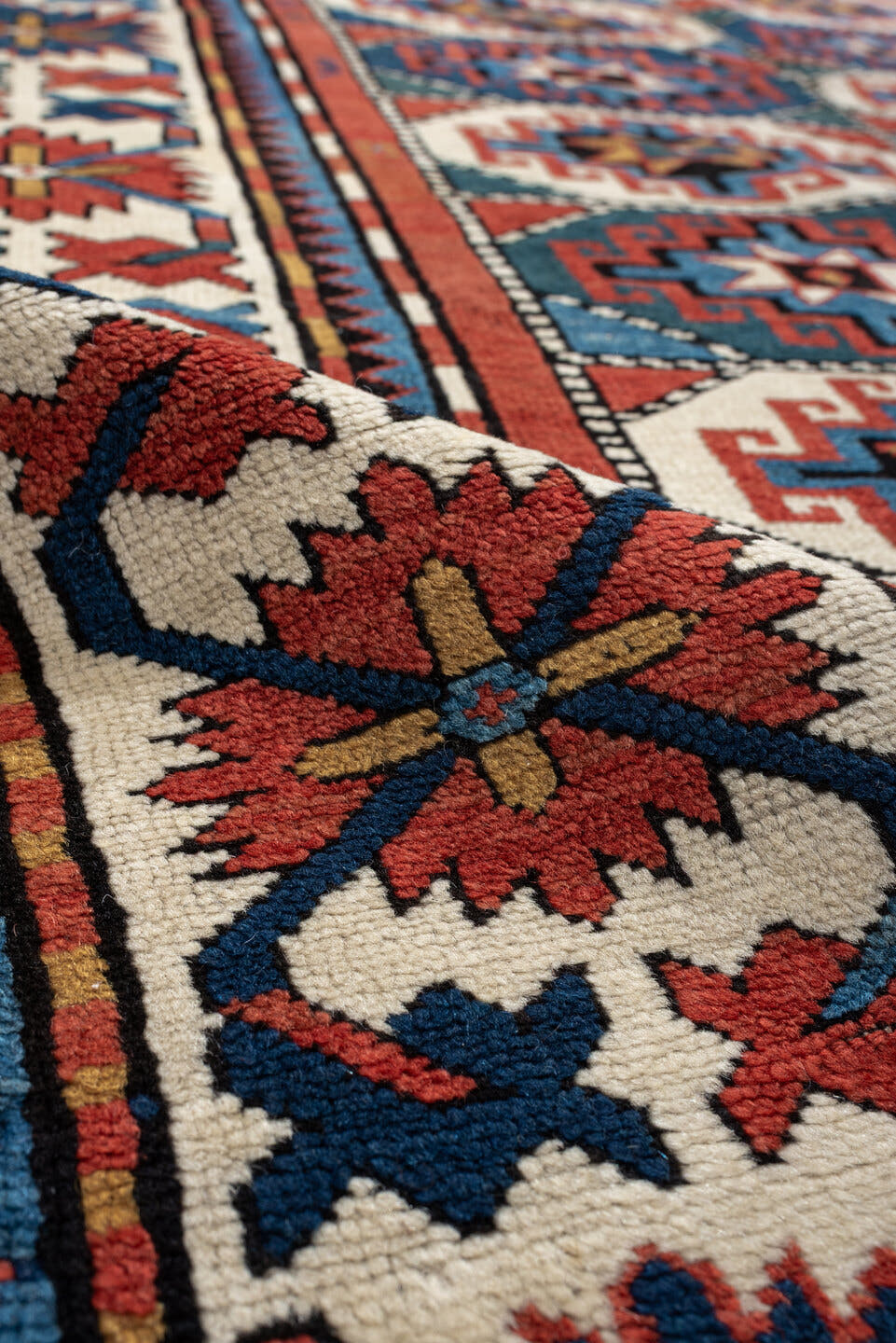 4' x 8' one-of-a-kind handmade vintage Kazak medium size rug. Color palette: teal, ivory, rust, navy, coral, charcoal, gold