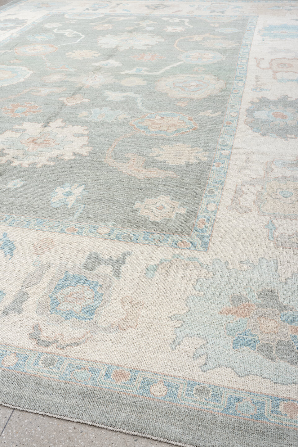 13' x 17' one-of-a-kind handmade vintage Oushak oversize rug. Color palette: pale blue, ivory, taupe, blush, cream, sky blue