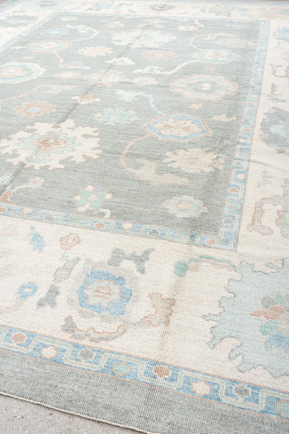 12' x 15' one-of-a-kind handmade vintage Oushak oversize rug. Color palette: pale blue, ivory, taupe, peach, sage, charcoal