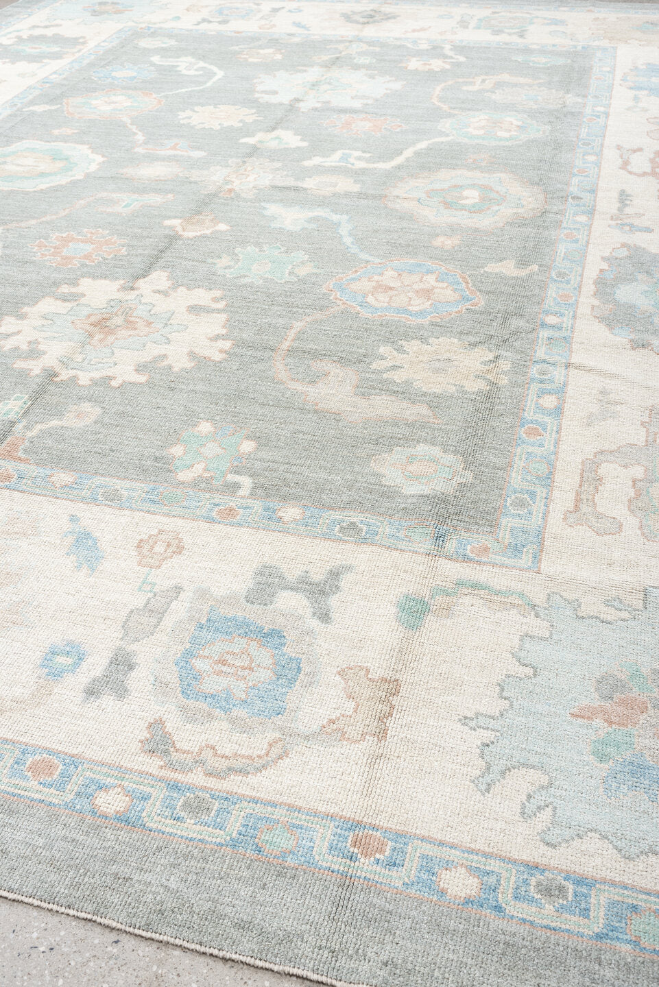 12' x 15' one-of-a-kind handmade vintage Oushak oversize rug. Color palette: pale blue, ivory, taupe, peach, sage, charcoal