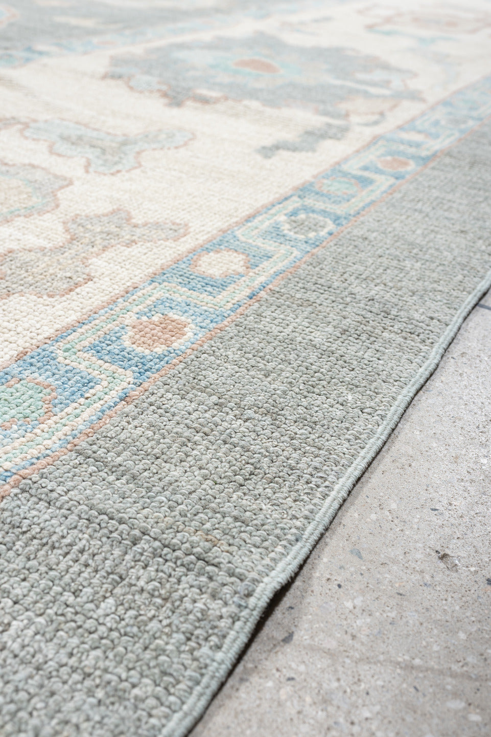 12' x 15' one-of-a-kind handmade vintage Oushak oversize rug. Color palette: pale blue, ivory, taupe, peach, sage, charcoal