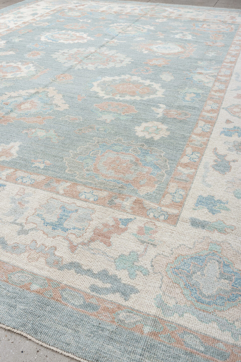 12' x 15' one-of-a-kind handmade vintage Oushak oversize rug. Color palette: sky blue, ivory, blush, pale blue, taupe, sage