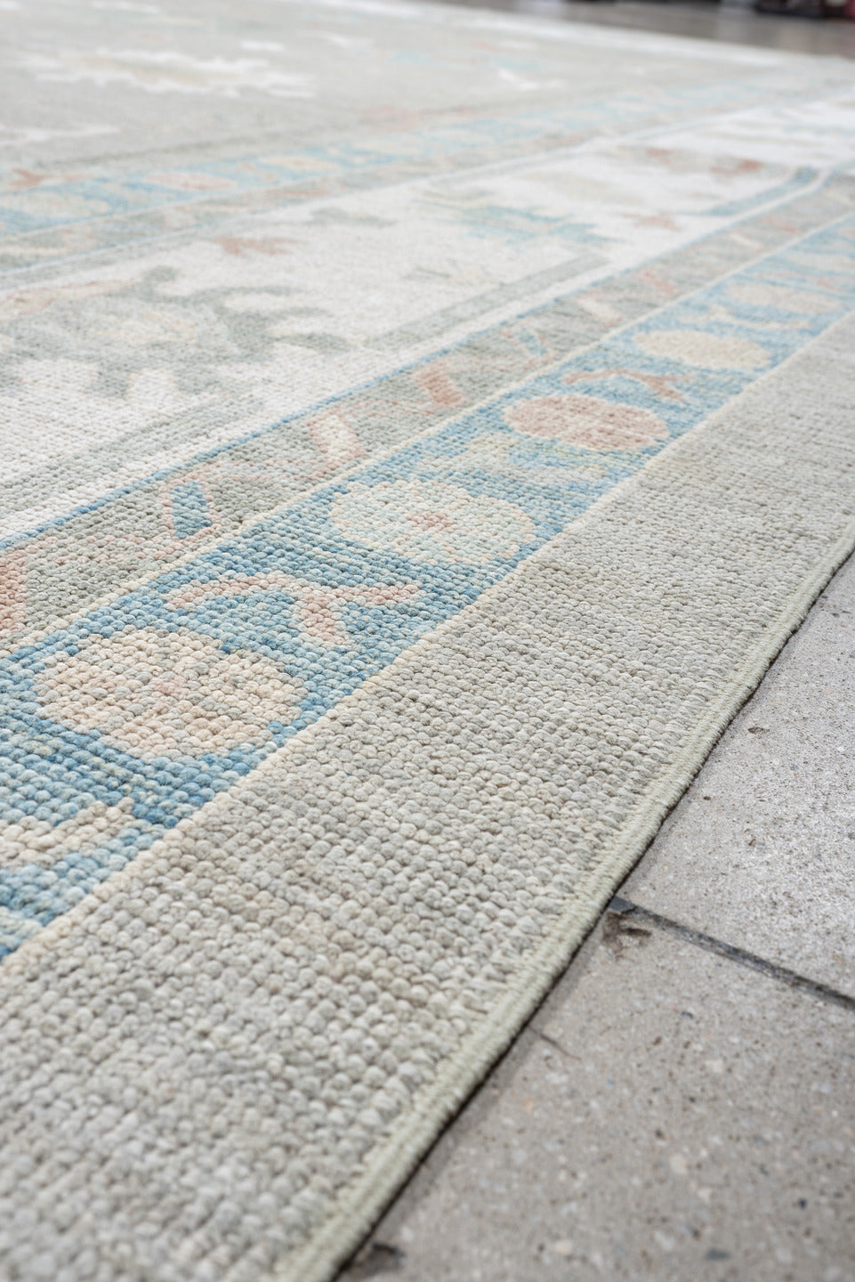 12' x 15' one-of-a-kind handmade vintage Oushak oversize rug. Color palette: pale gray, ivory, sky blue, peach, taupe, sage