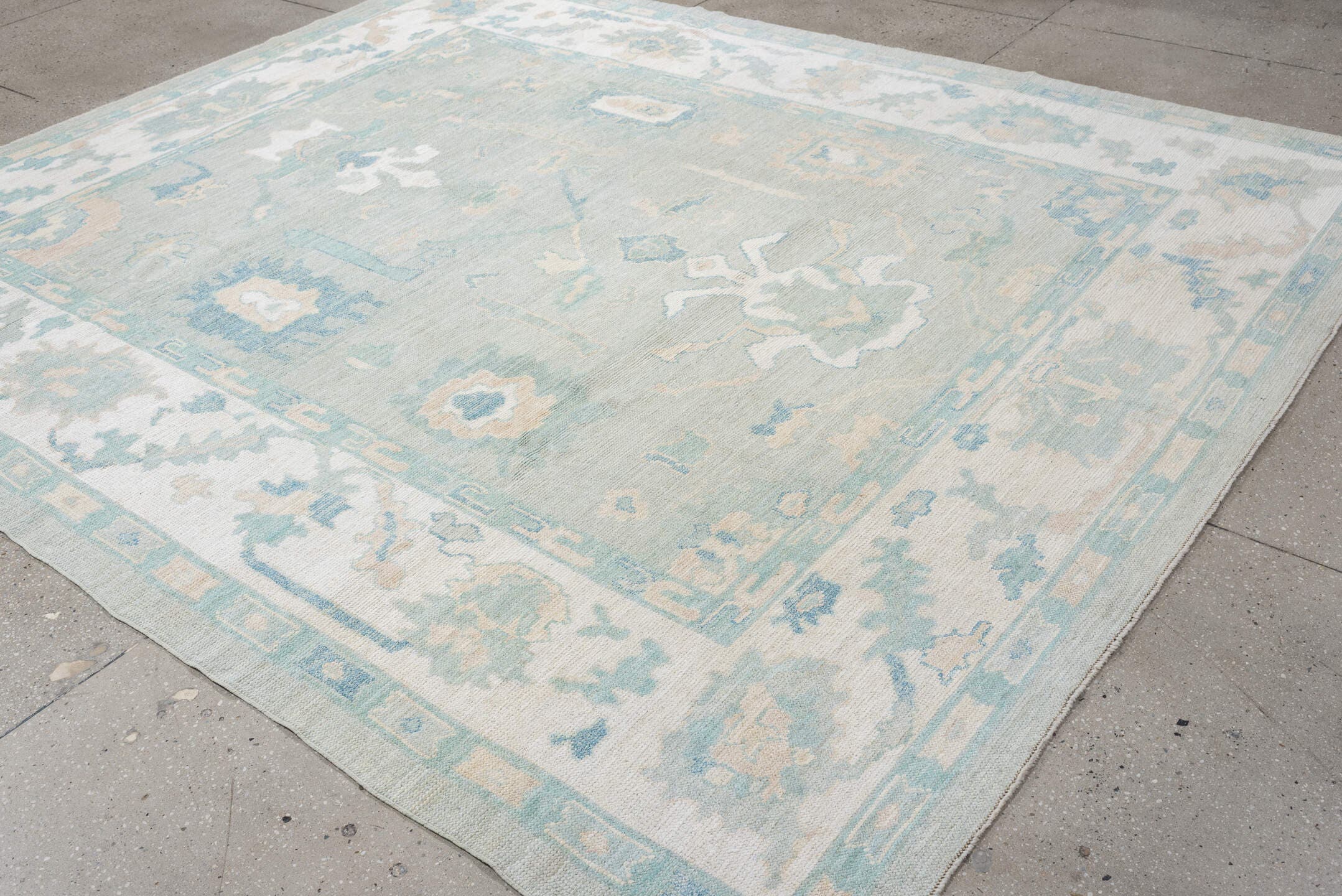 8' x 10' one-of-a-kind handmade vintage Oushak large size rug. Color palette: pale aqua, ivory, sky blue, taupe, cream, sage