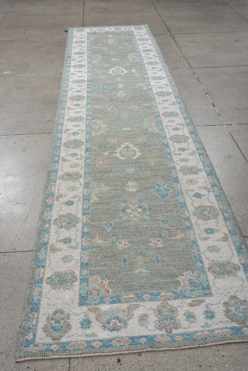 3' x 12' one-of-a-kind handmade vintage Oushak runner rug. Color palette: sage, ivory, aqua, blush, taupe, cream, green