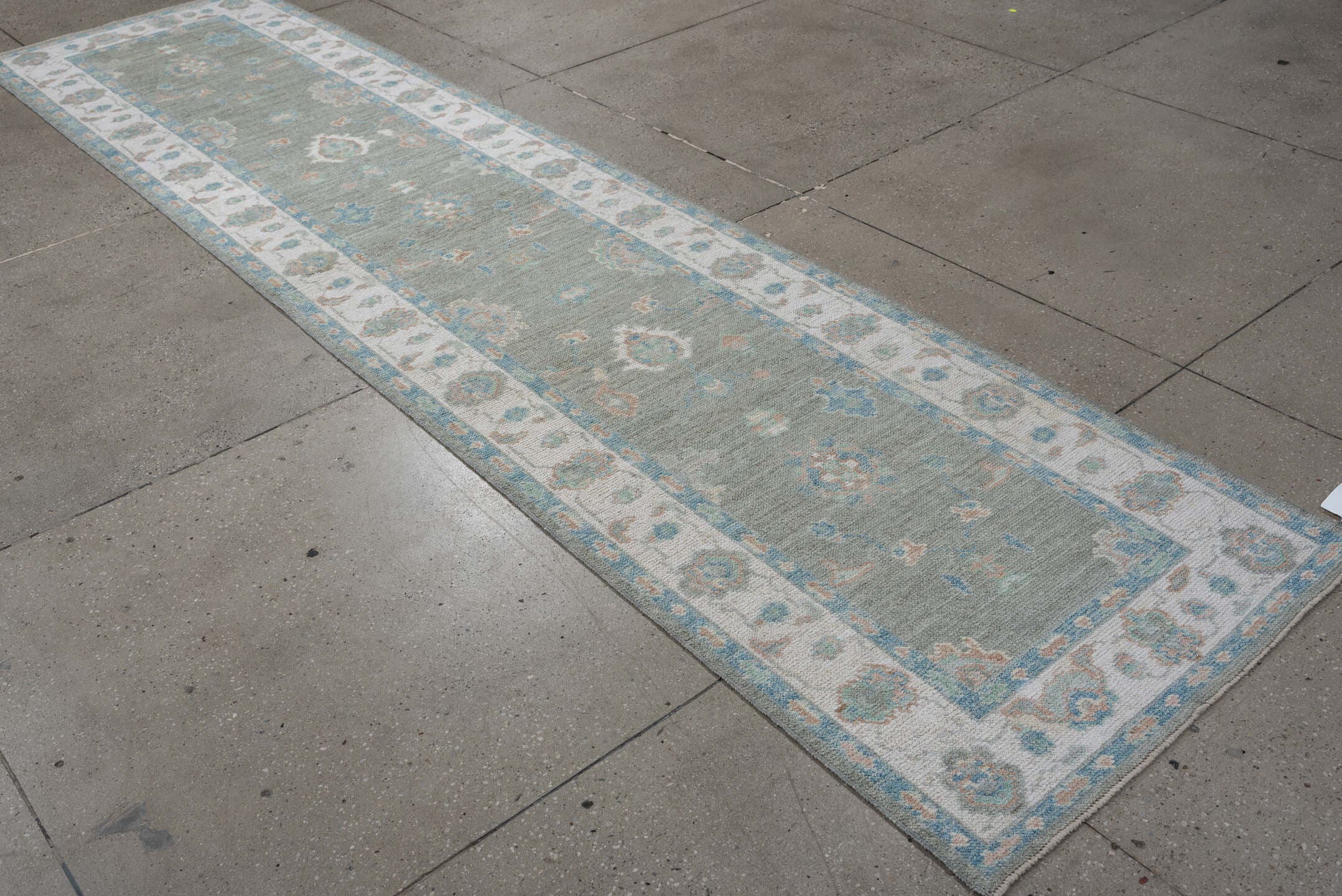3' x 12' one-of-a-kind handmade vintage Oushak runner rug. Color palette: sage, ivory, aqua, blush, taupe, cream, green
