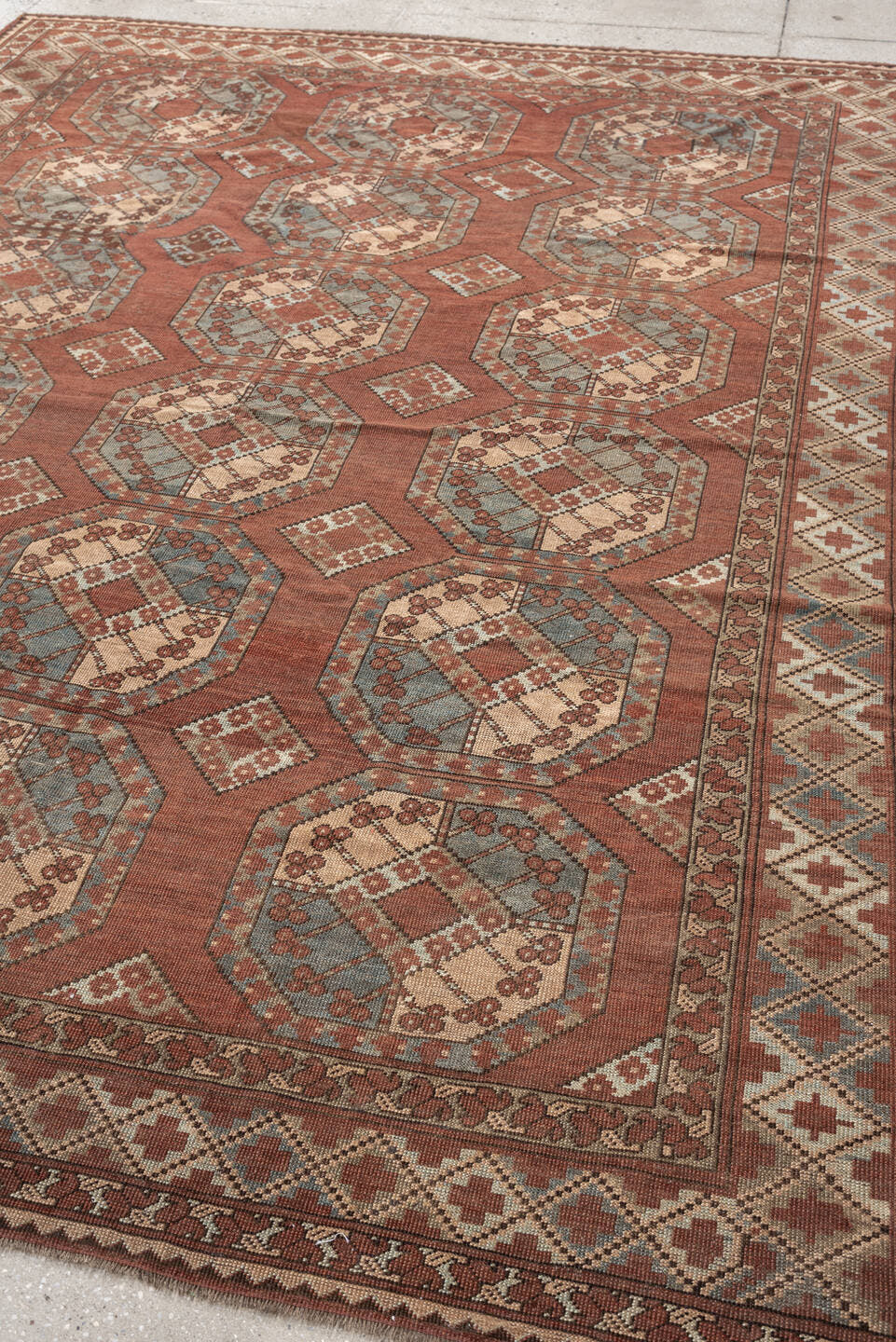 7' x 9' one-of-a-kind handmade vintage Afghan rug. Color palette: terracotta, ivory, blue gray, rust, taupe, camel, brown