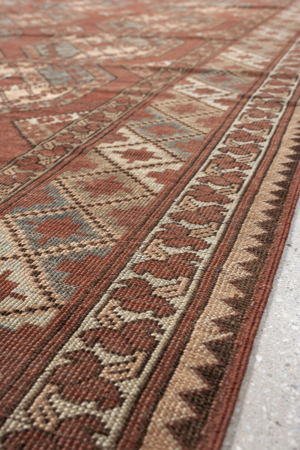 7' x 9' one-of-a-kind handmade vintage Afghan rug. Color palette: terracotta, ivory, blue gray, rust, taupe, camel, brown