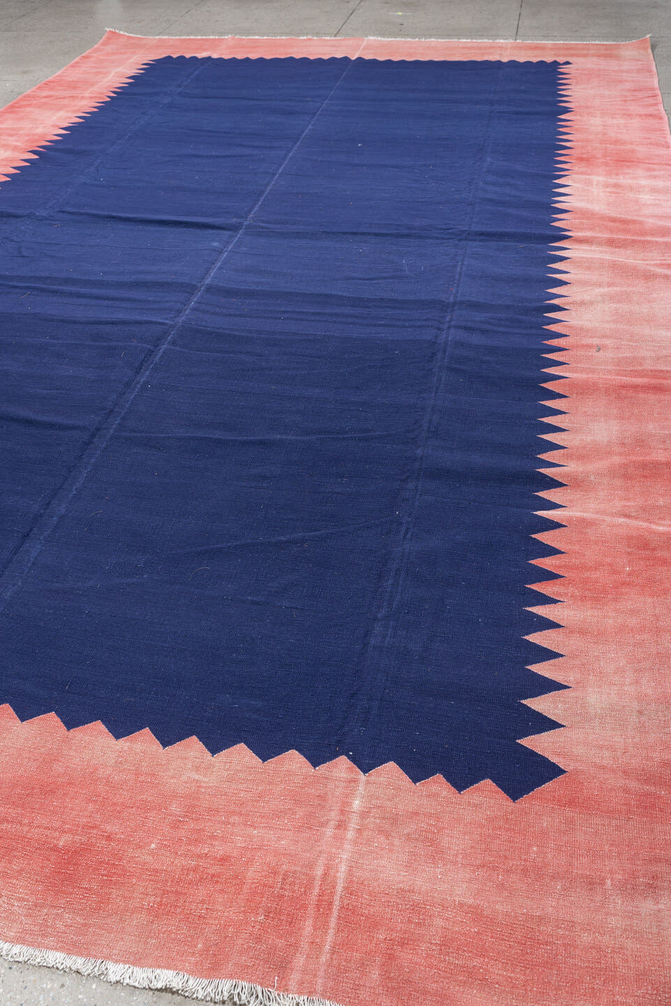 9' x 15' one-of-a-kind handmade antique Cot Dhurrie rug. Color palette: indigo, coral, rose, navy, ivory, purple, terracotta
