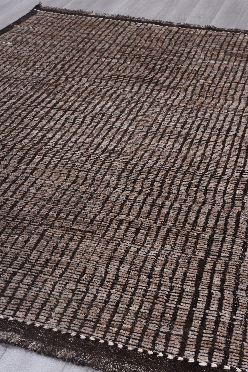 8' x 9' one-of-a-kind handmade vintage Tulu rug. Color palette: taupe, brown, charcoal, ivory, beige, gray, black