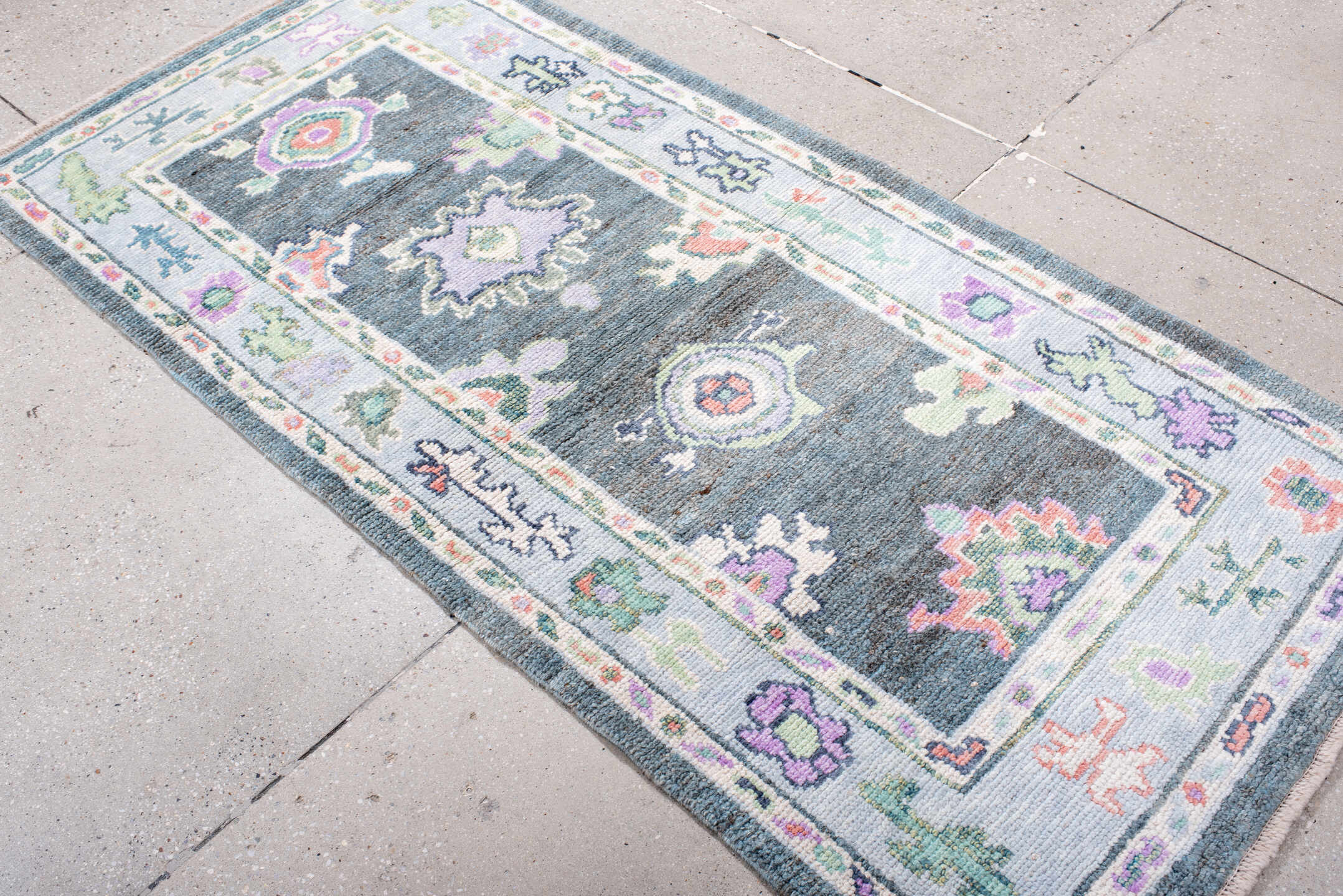 3' x 6' one-of-a-kind handmade vintage Oushak runner rug. Color palette: charcoal, ivory, lavender, sage, soft blue, coral
