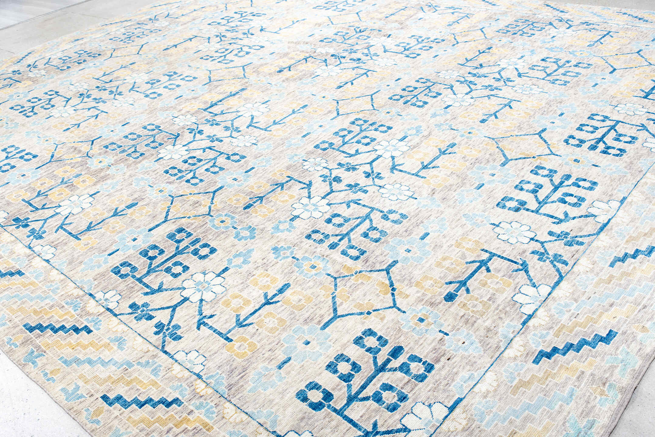 13' x 17' one-of-a-kind handmade vintage Khotan oversize rug. Color palette: ivory, light blue, cobalt, gold, taupe, blue