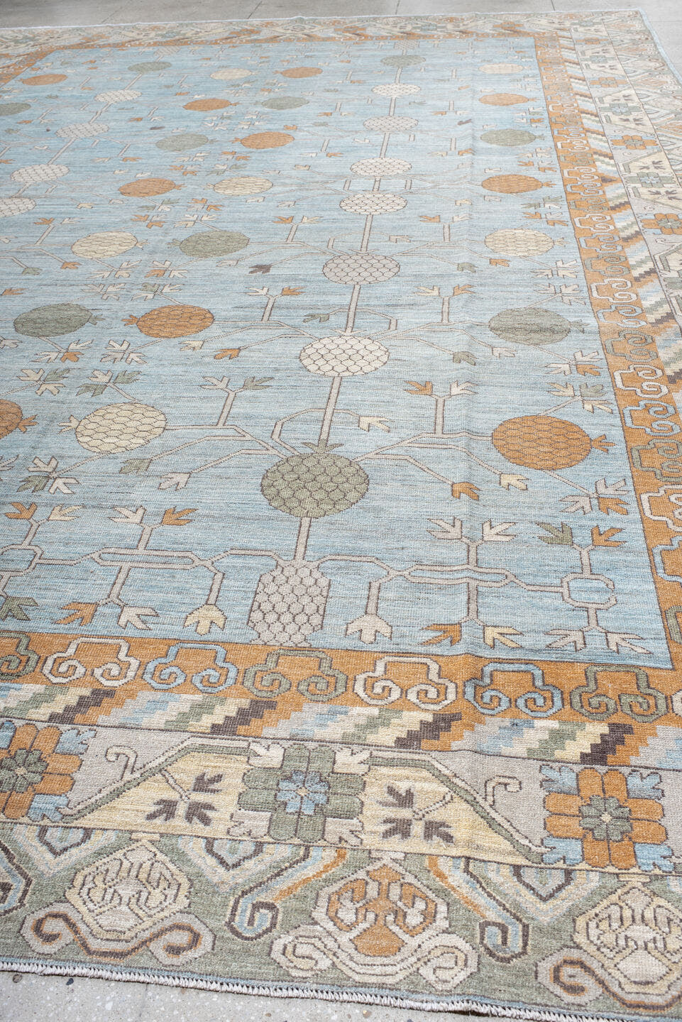 13' x 19' one-of-a-kind handmade vintage Khotan oversize rug. Color palette: pale blue, ivory, peach, taupe, sage, camel