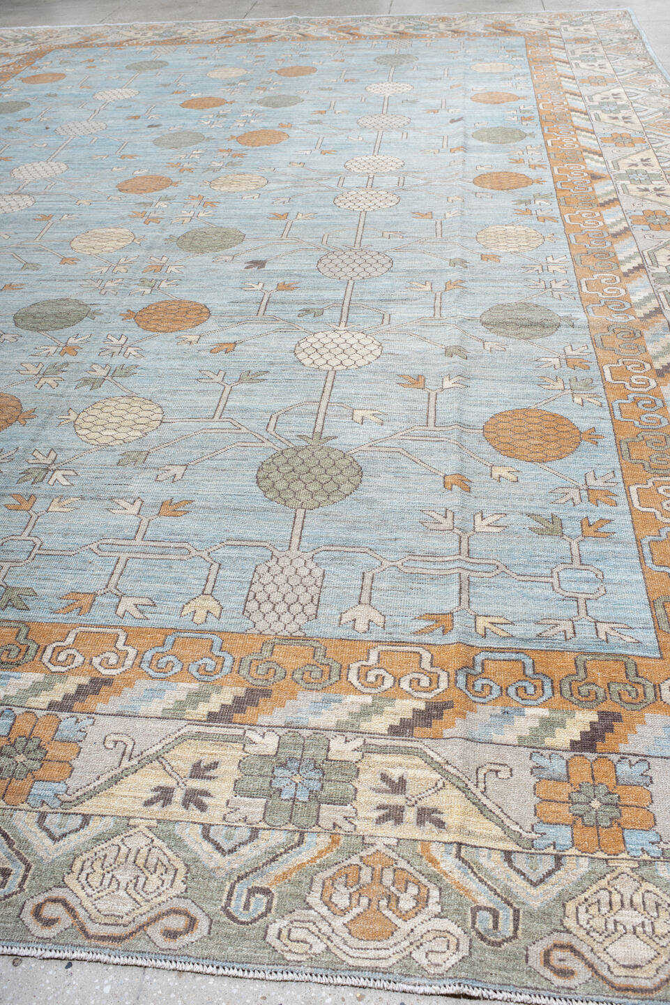13' x 19' one-of-a-kind handmade vintage Khotan oversize rug. Color palette: pale blue, ivory, peach, taupe, sage, camel